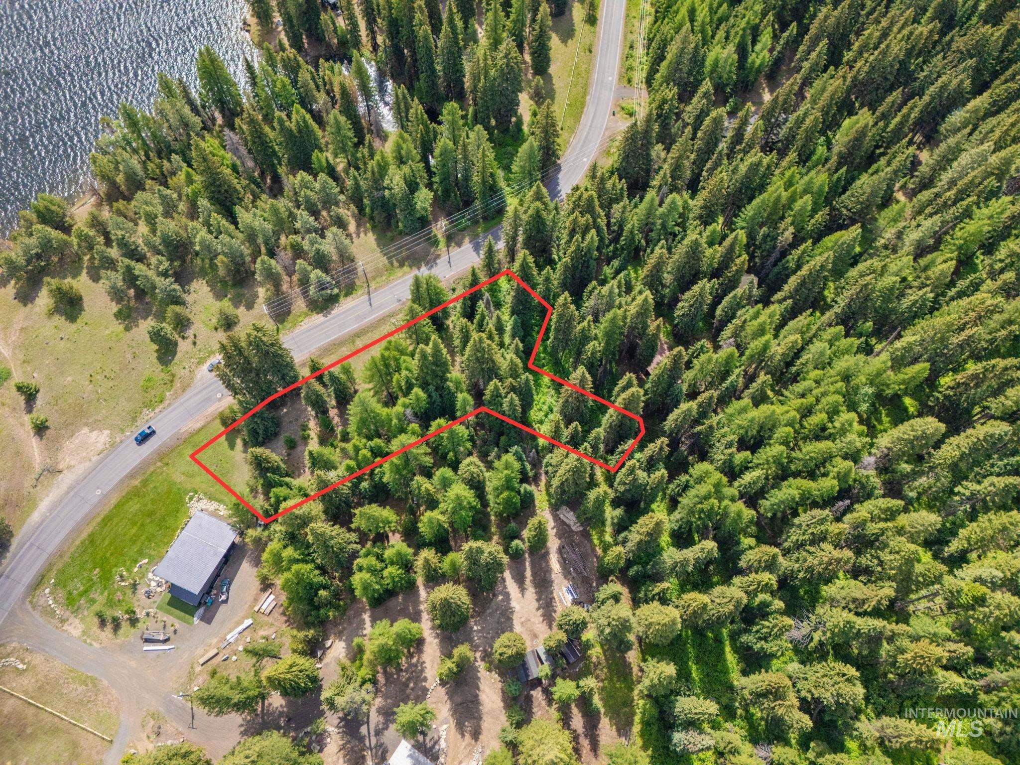 Aerial overview of property's location featuring property boundaries highlighted and a large body of water