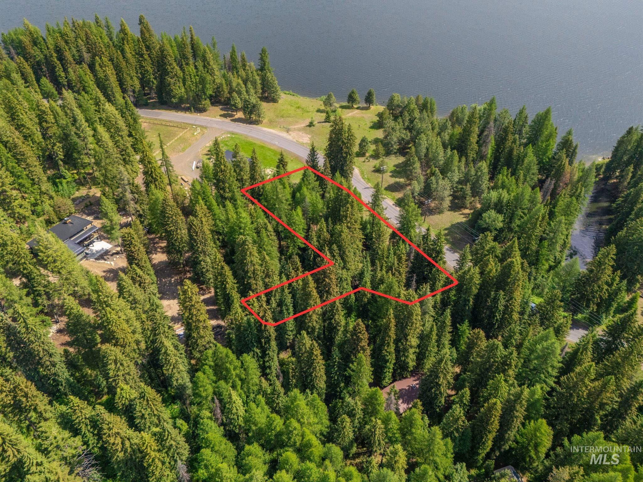 Aerial view of property's location with property parcel outlined and a nearby body of water