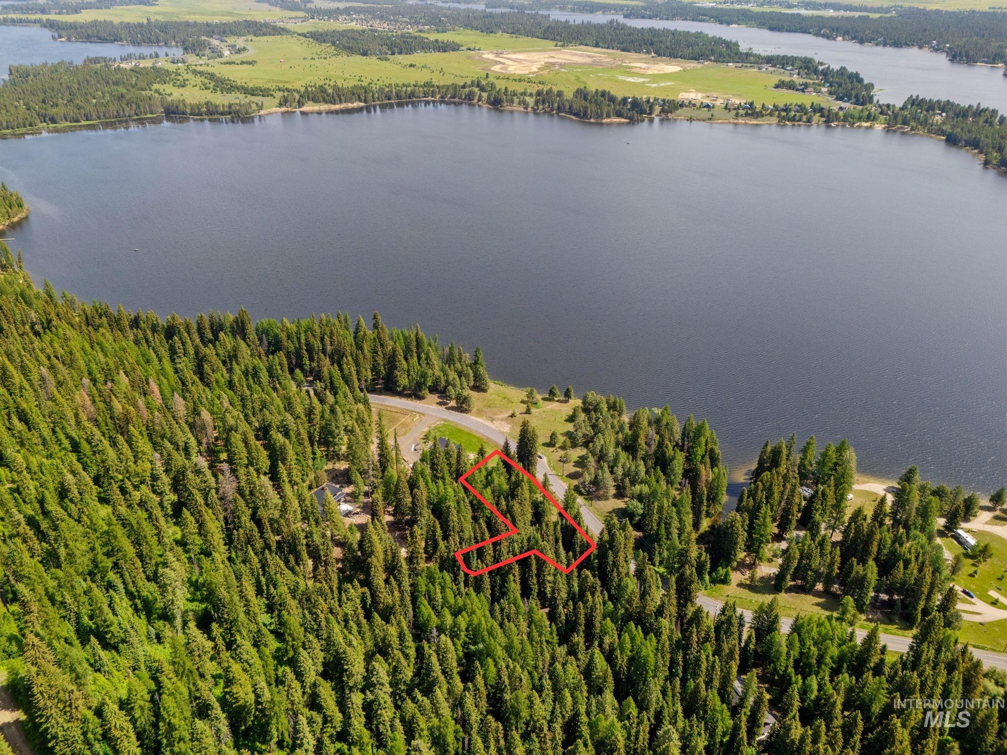 Aerial view of property's location featuring a large body of water and property boundaries highlighted