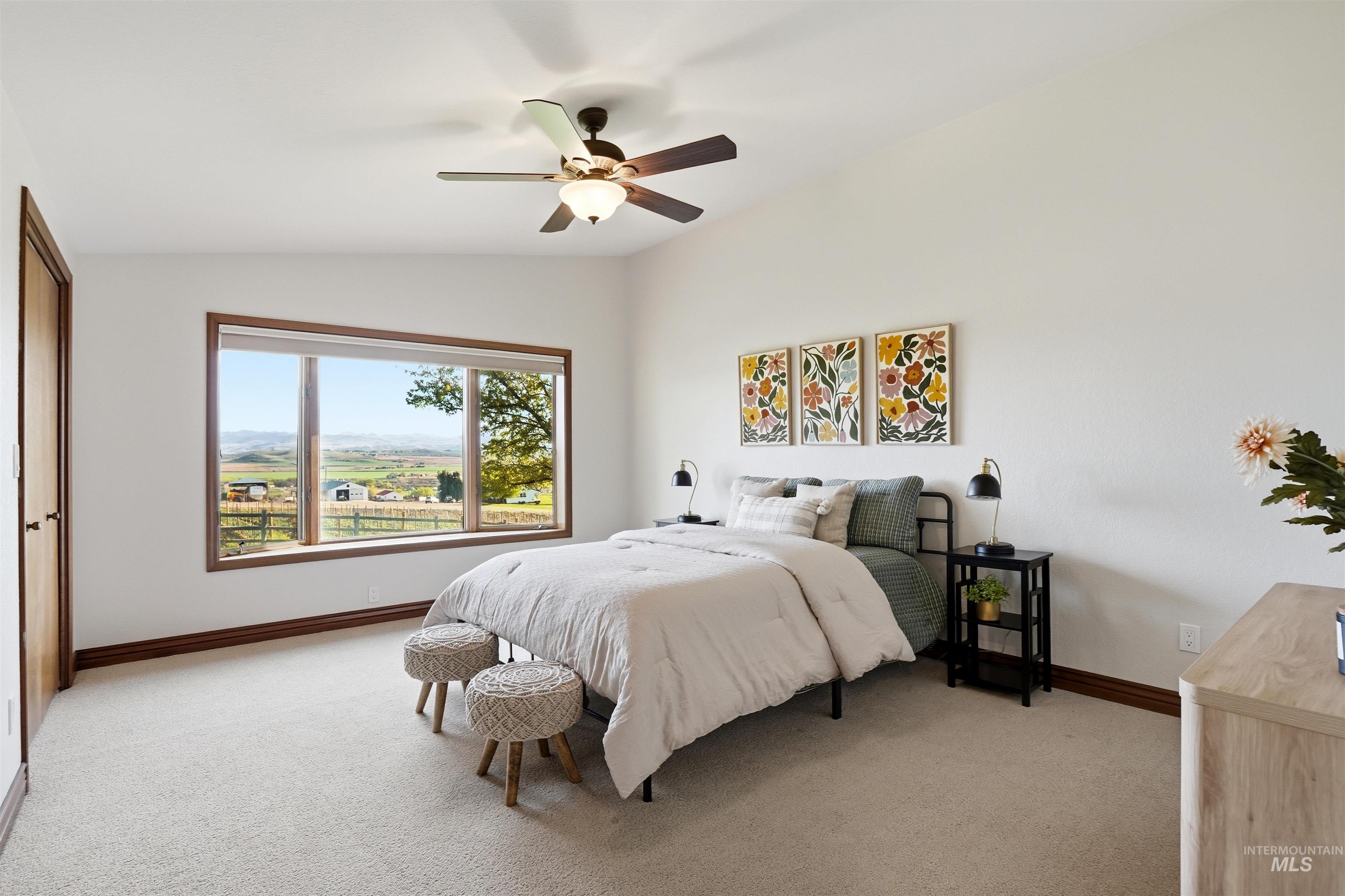 Bedroom with light carpet, vaulted ceiling, and a ceiling fan
