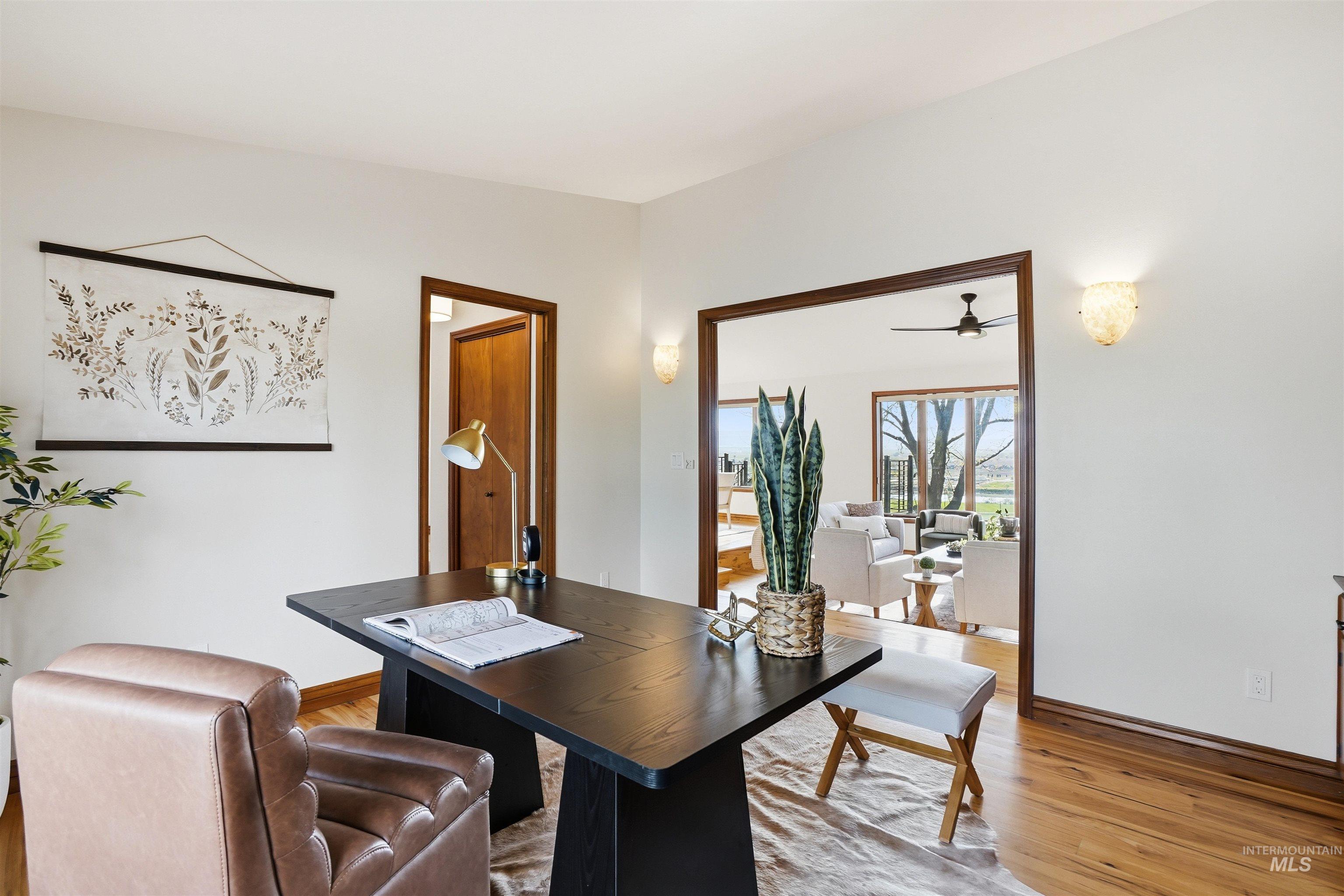 Home office featuring light wood-type flooring and ceiling fan