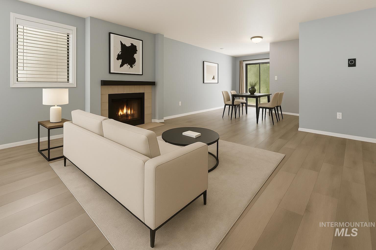 Living area with a tiled fireplace and light wood-style floors