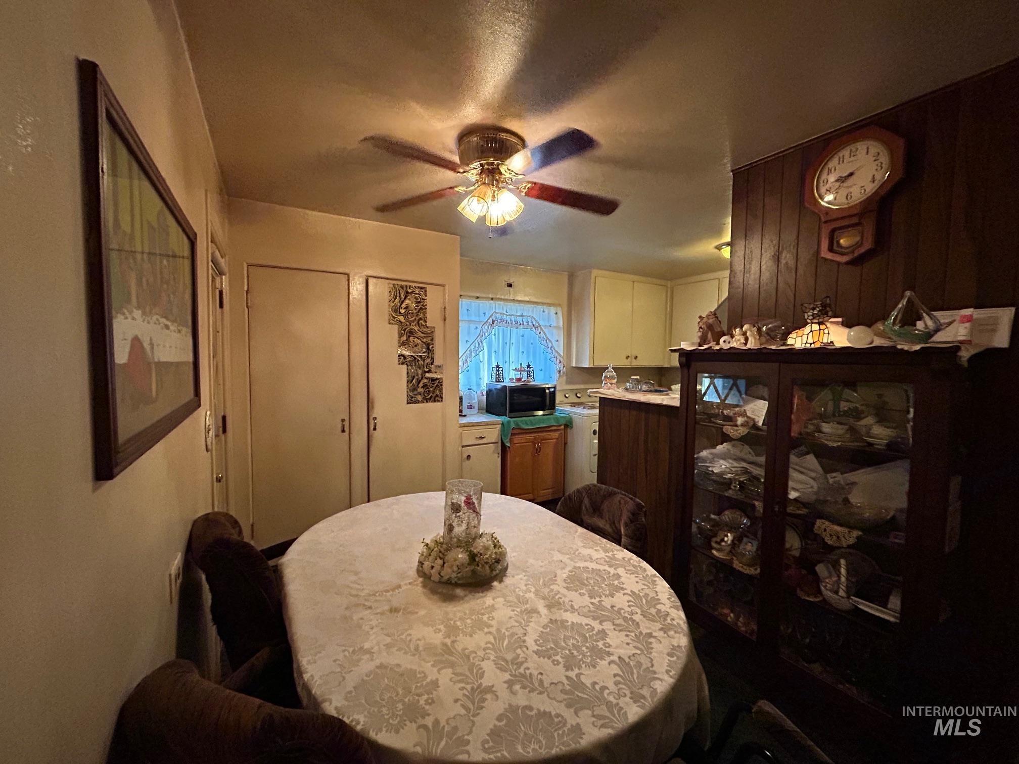 Dining area featuring ceiling fan and a textured ceiling