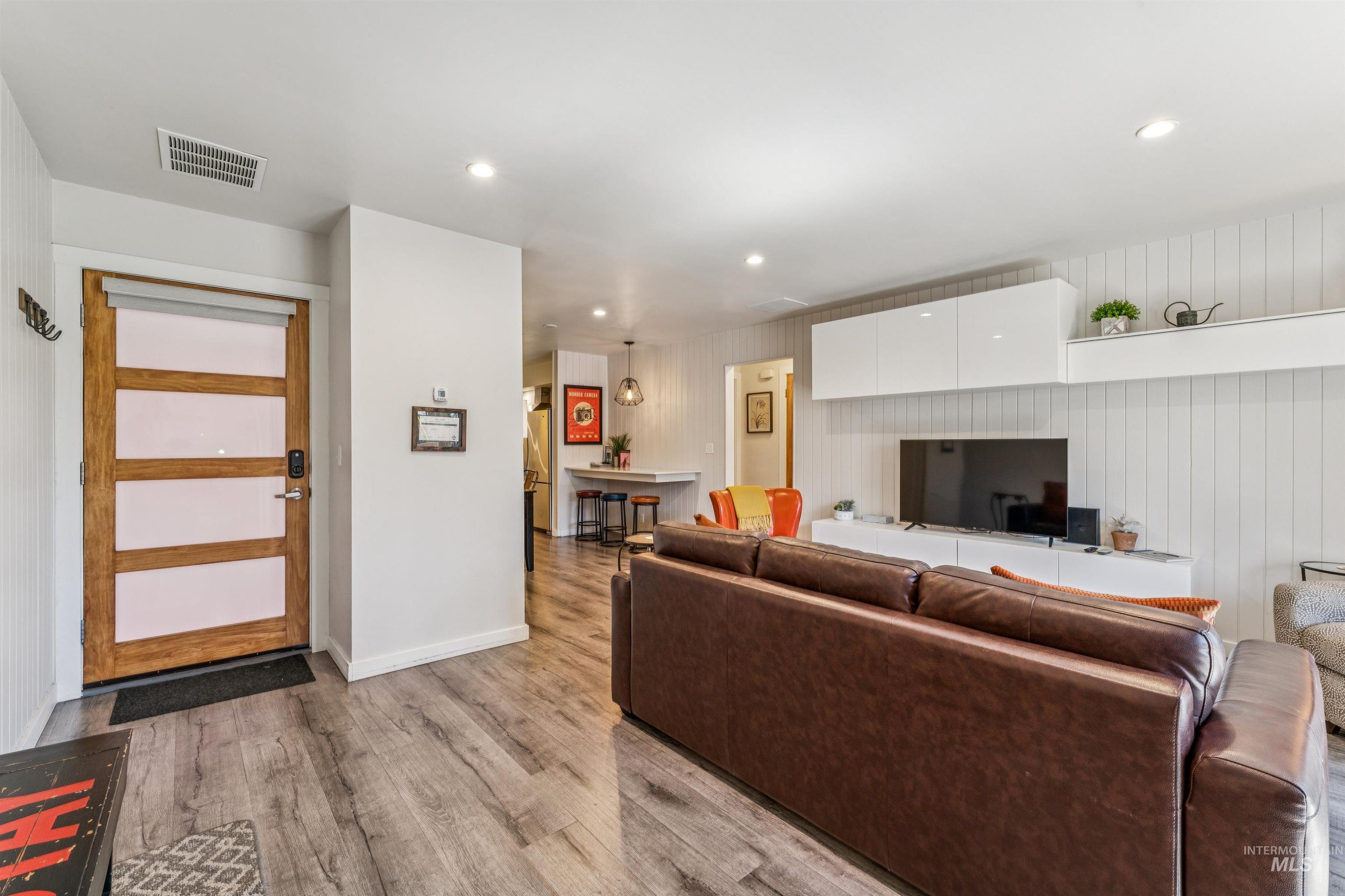Living room featuring recessed lighting and light wood-type flooring