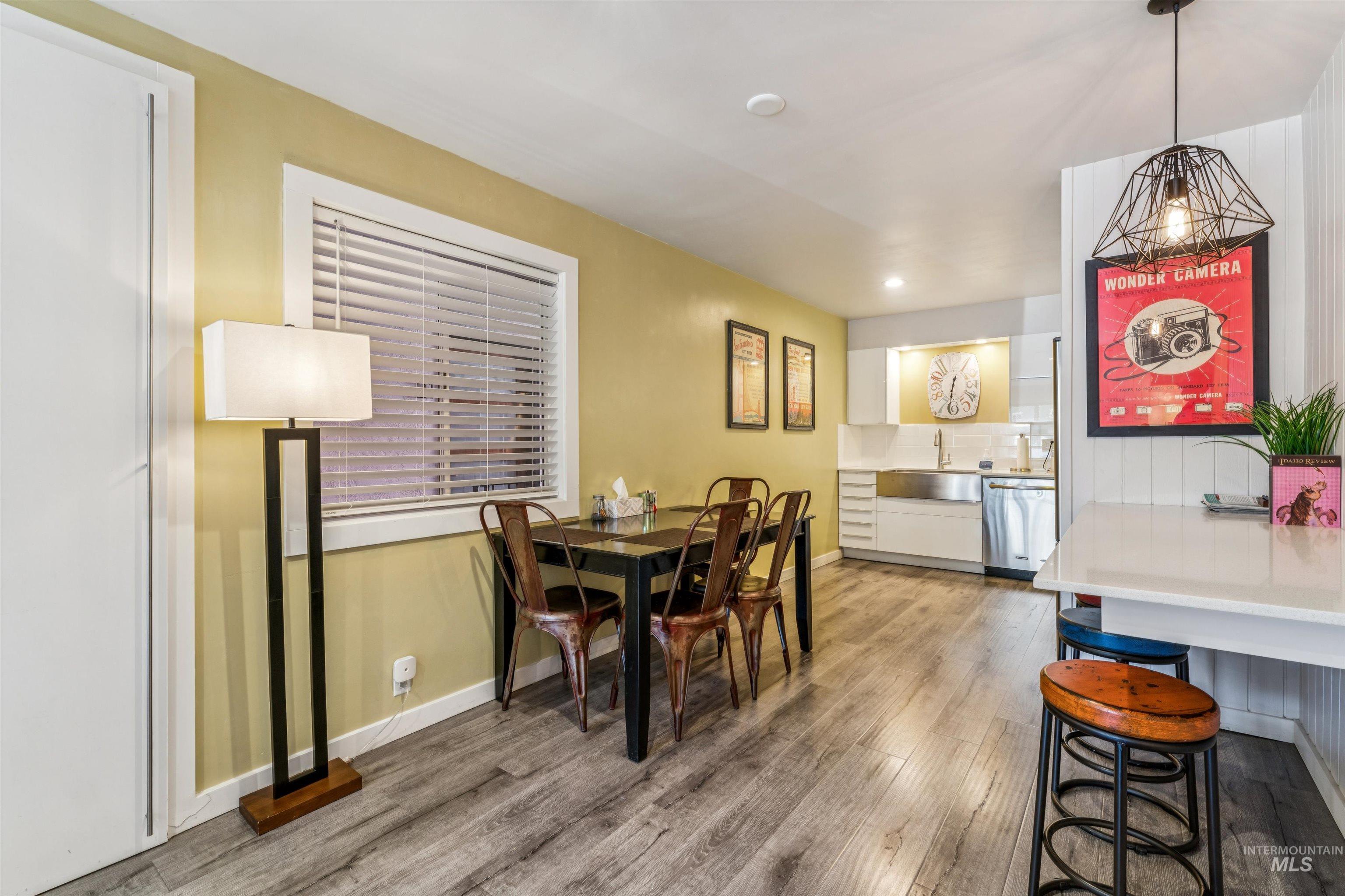 Dining area with light wood-type flooring and recessed lighting