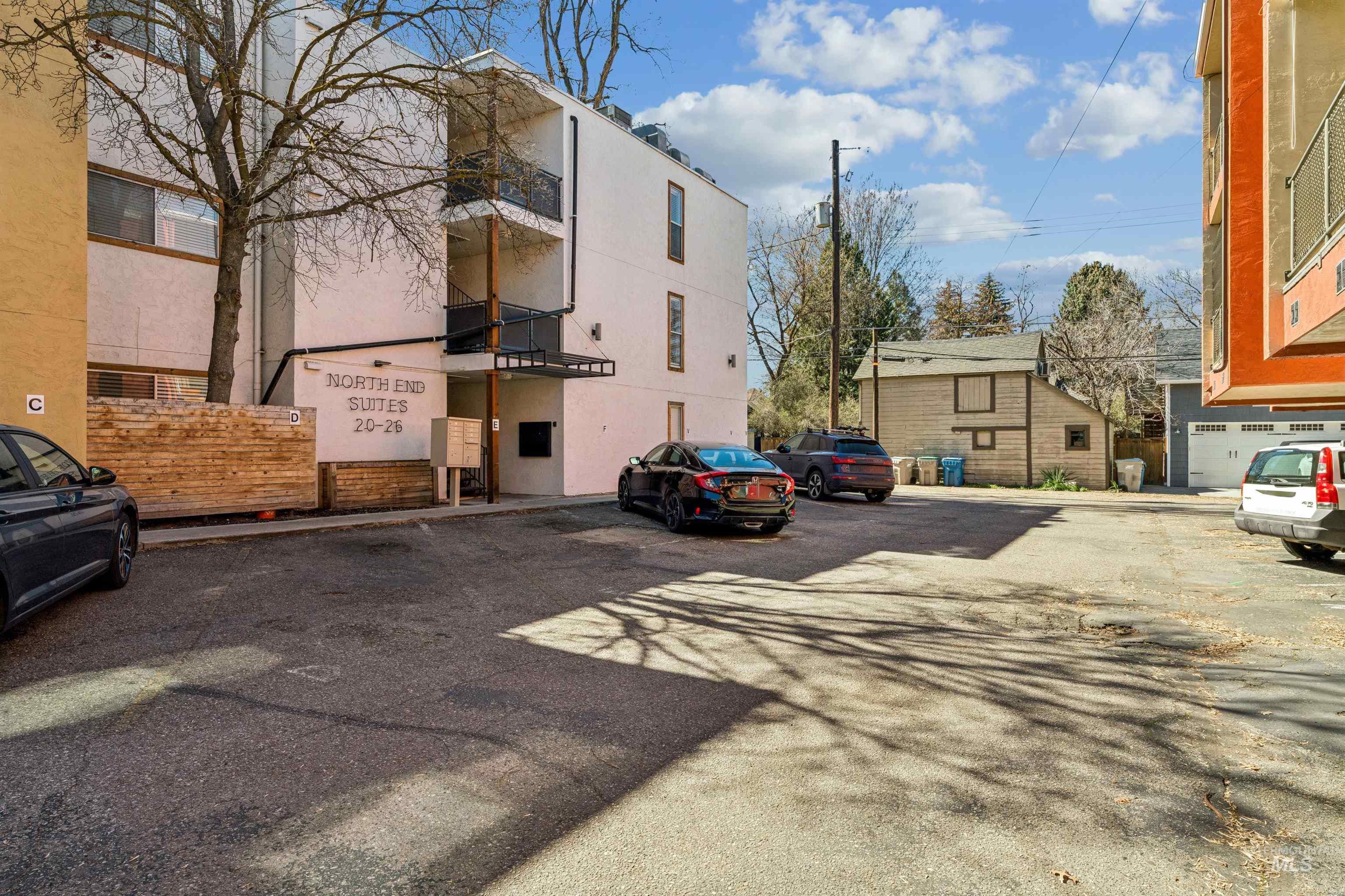 View of building exterior with uncovered parking