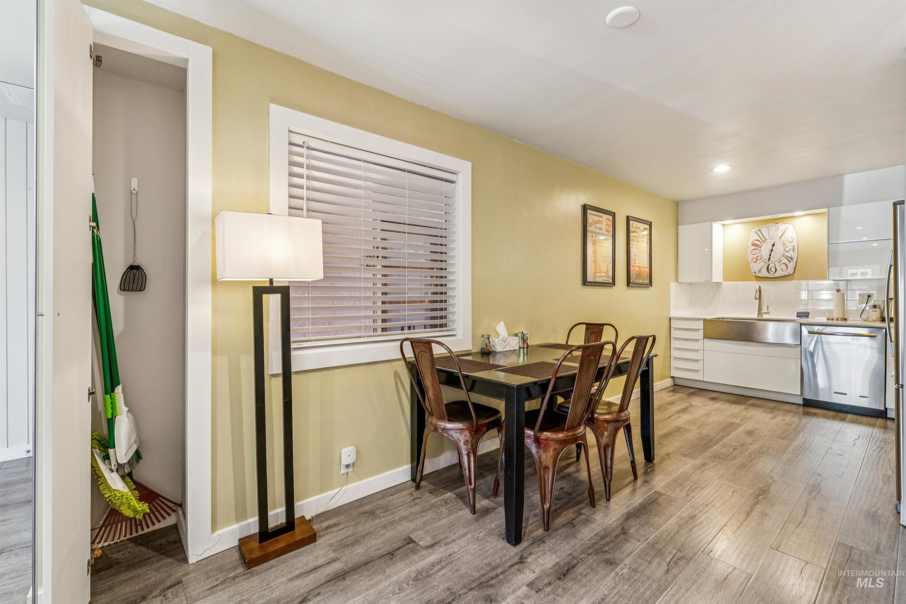 Dining space with light wood-type flooring and recessed lighting