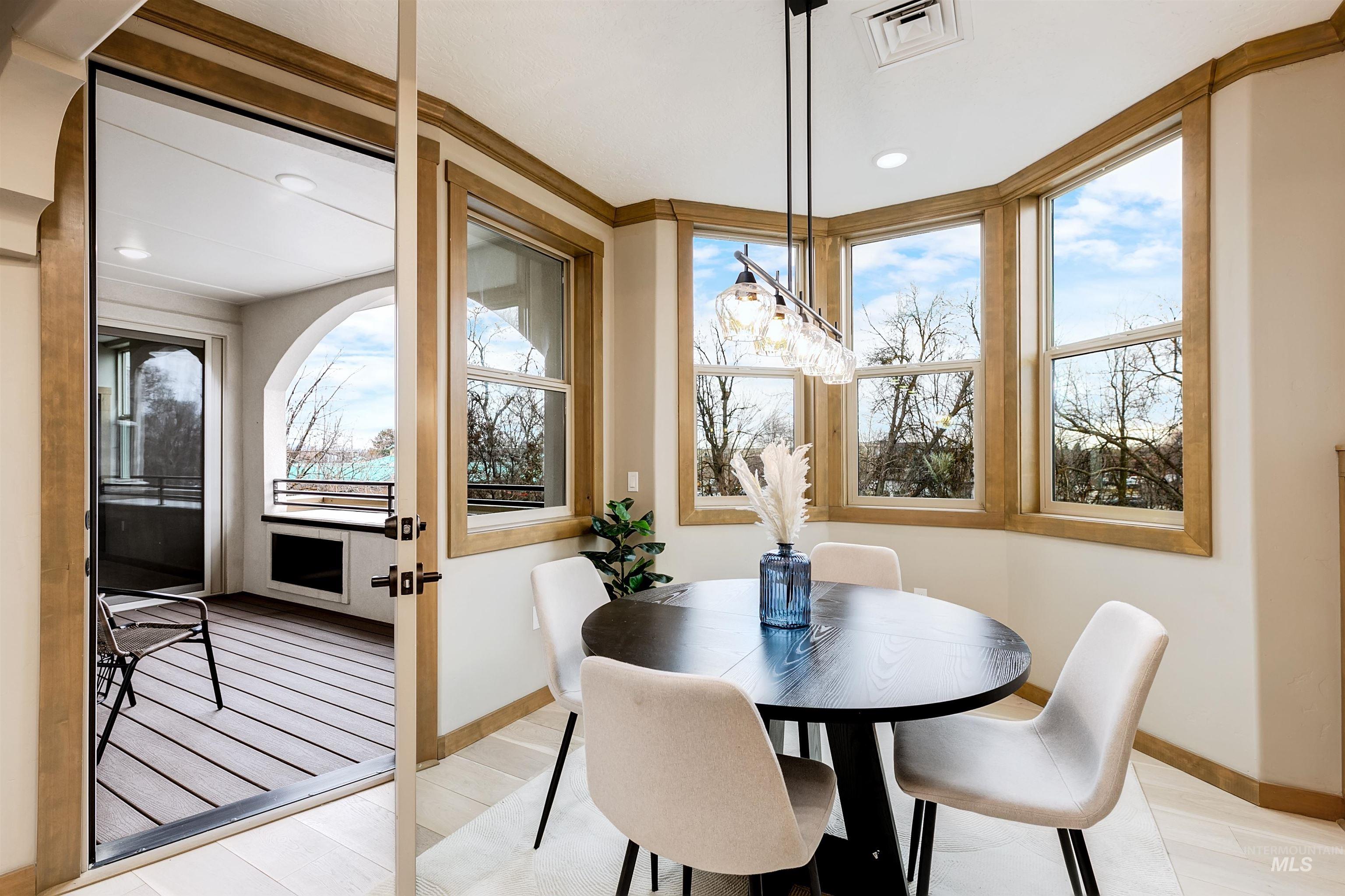 Dining room with light wood-type flooring and recessed lighting