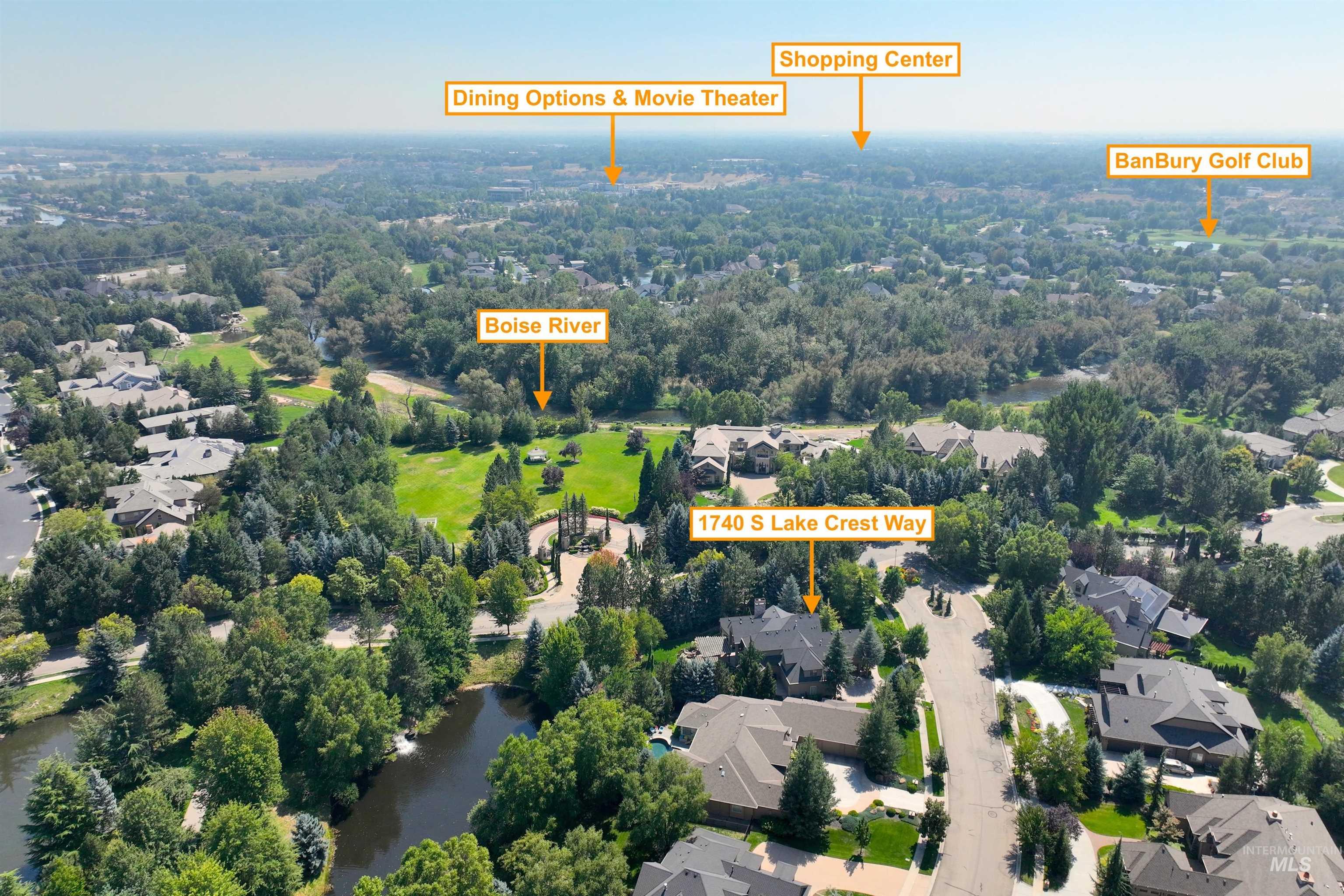 Aerial perspective of suburban area featuring a nearby body of water