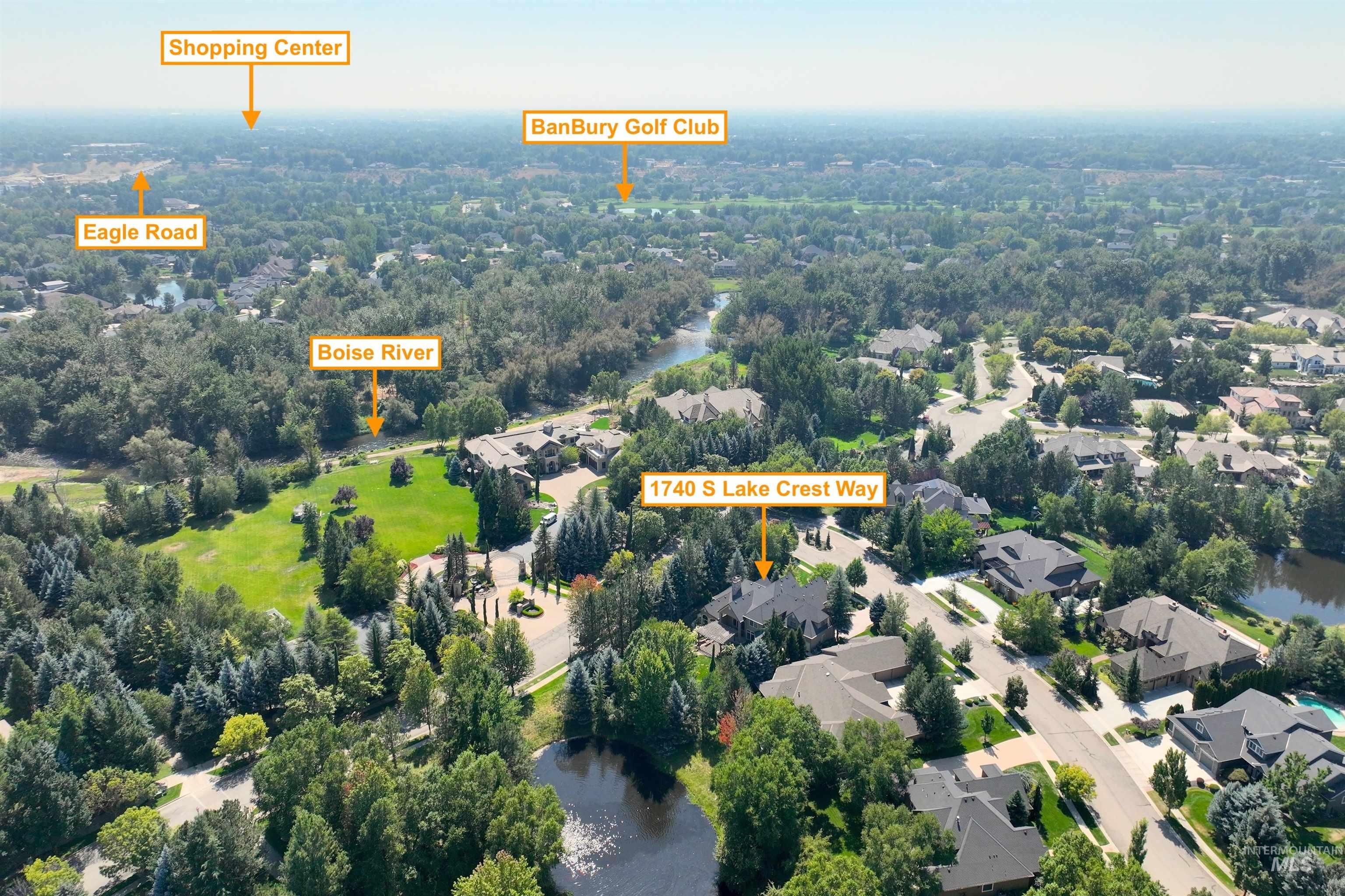 Aerial view of property and surrounding area with a large body of water and nearby suburban area