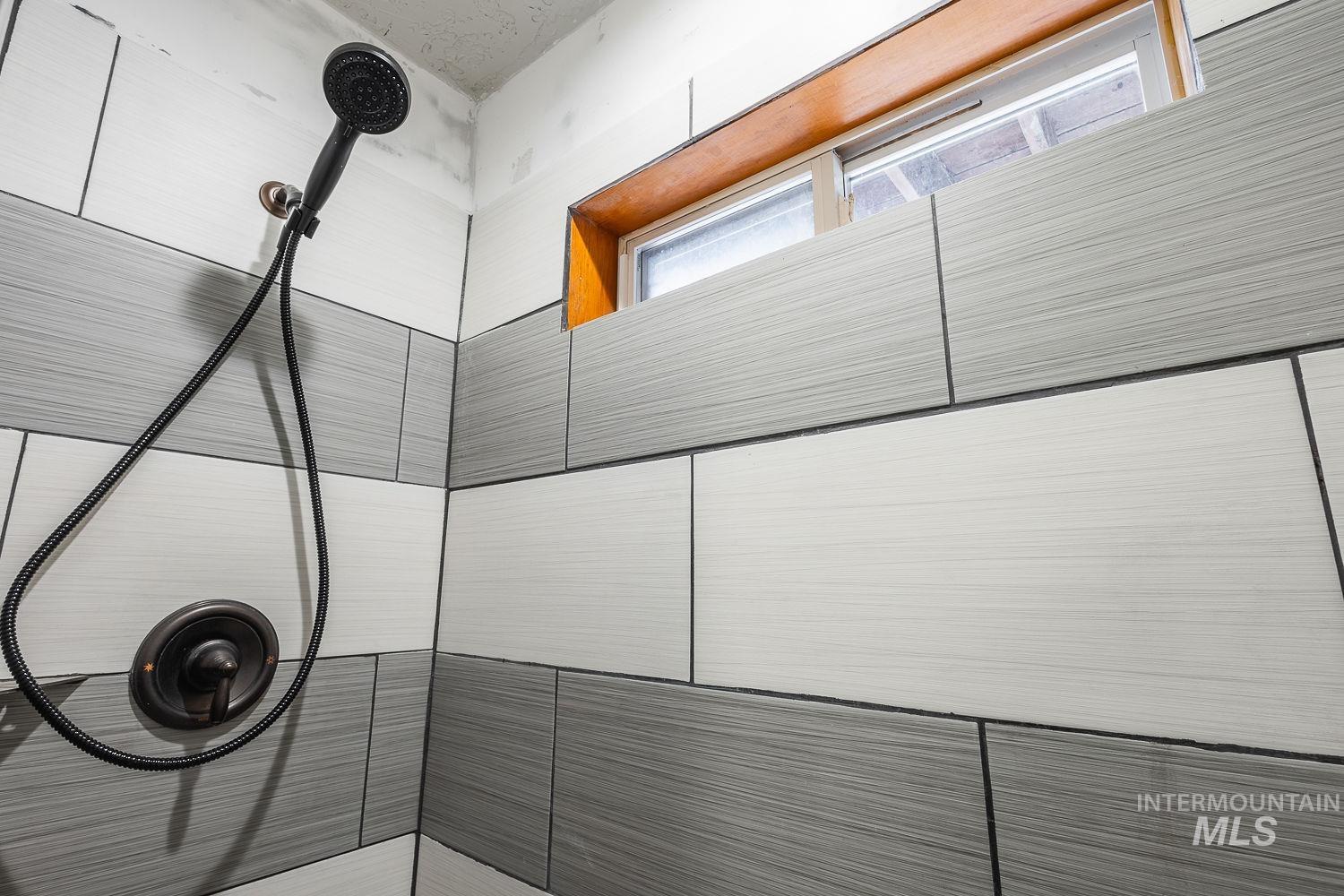 Bathroom view of a tile shower