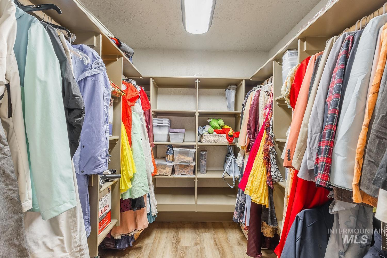 Spacious closet with light wood-style floors