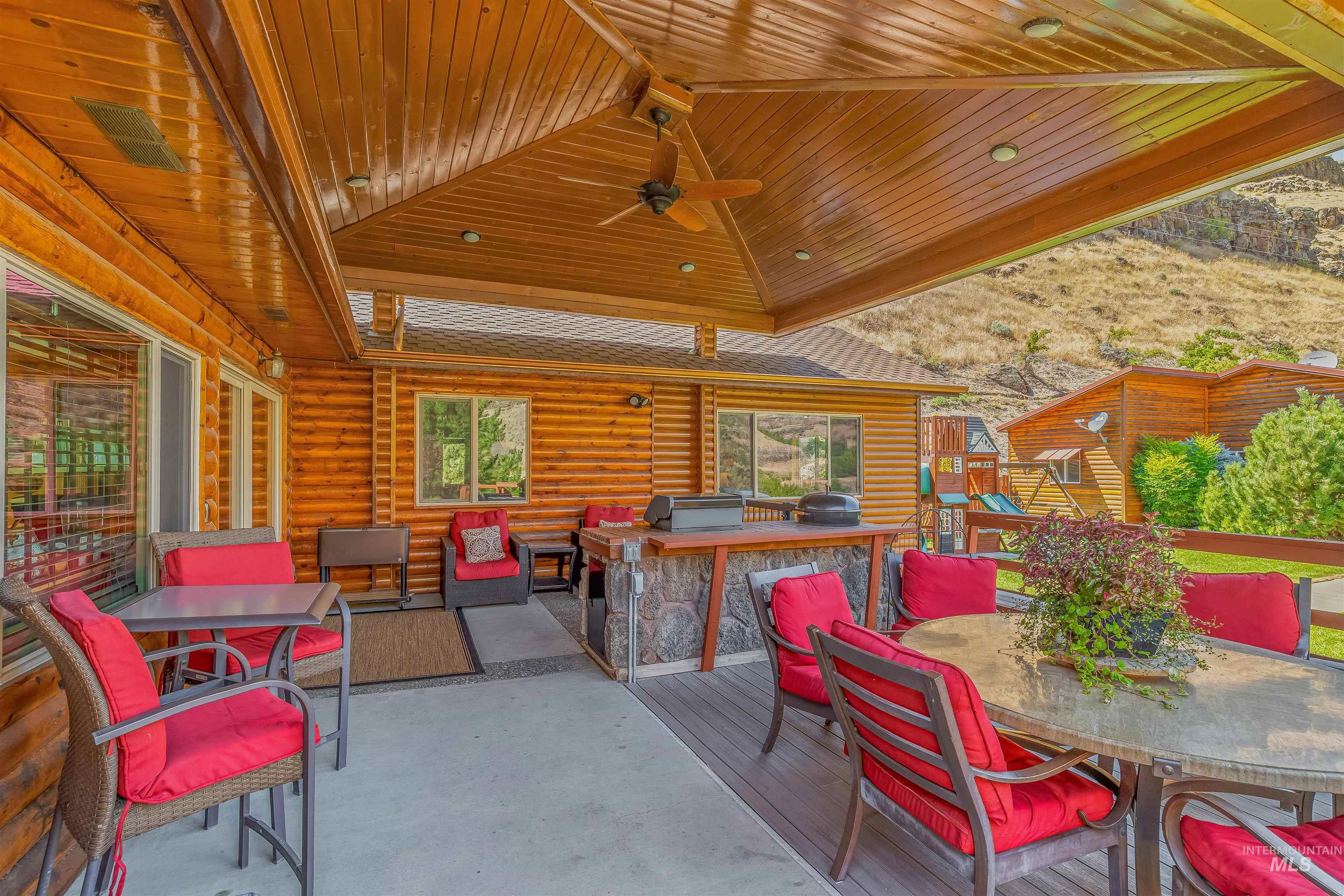 View of patio / terrace featuring outdoor dining space, a bar, area for grilling, and a ceiling fan