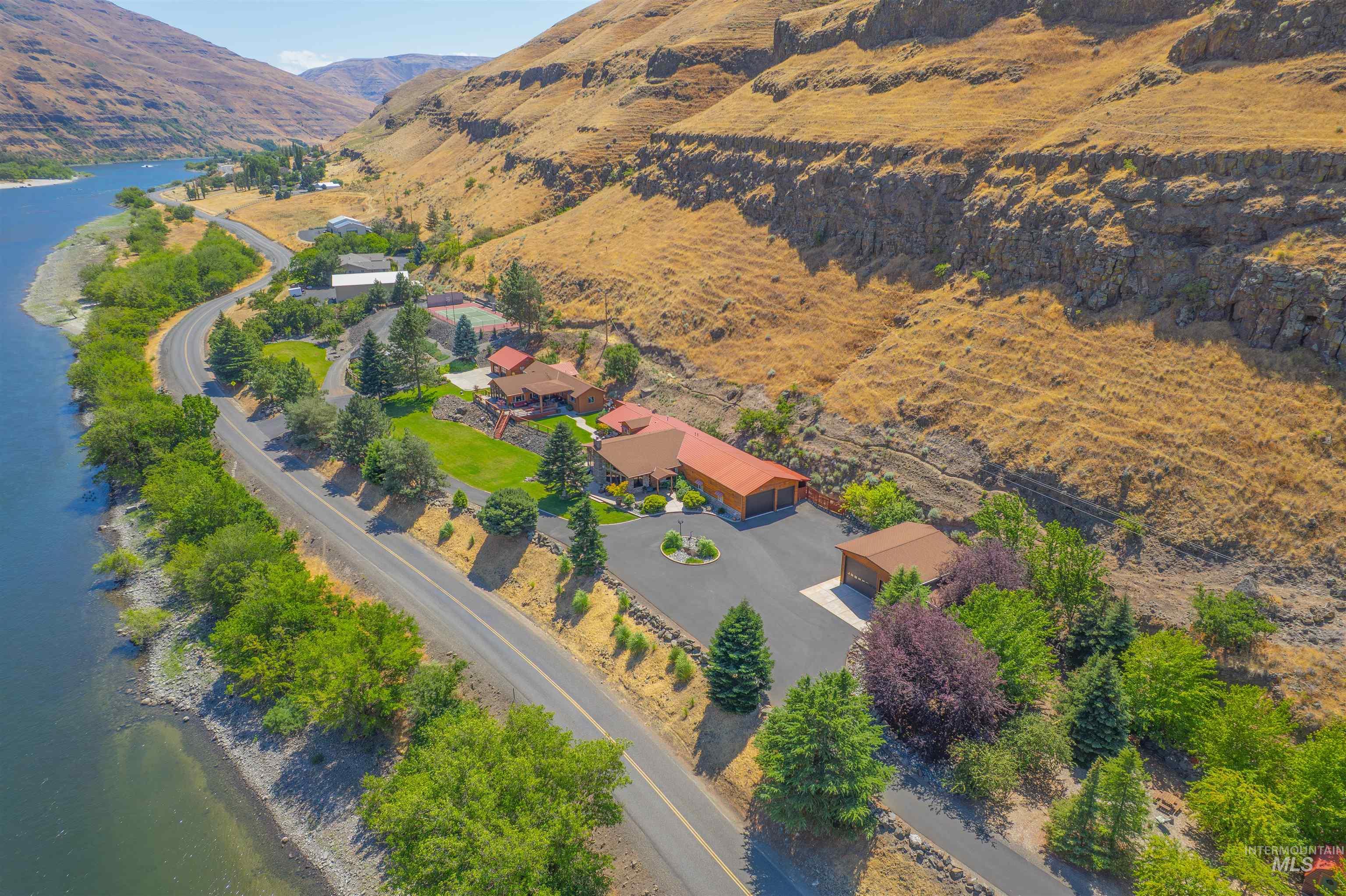 Aerial view of property and surrounding area with a water and mountain view