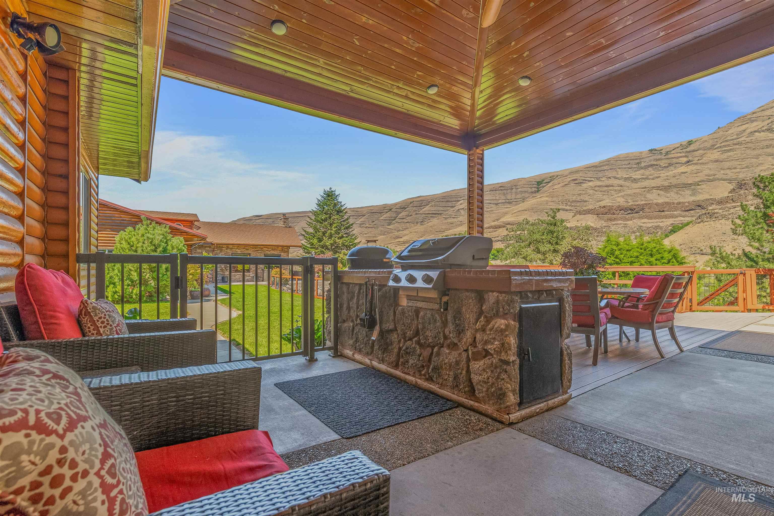 View of patio / terrace featuring area for grilling, a mountain view, and outdoor lounge area