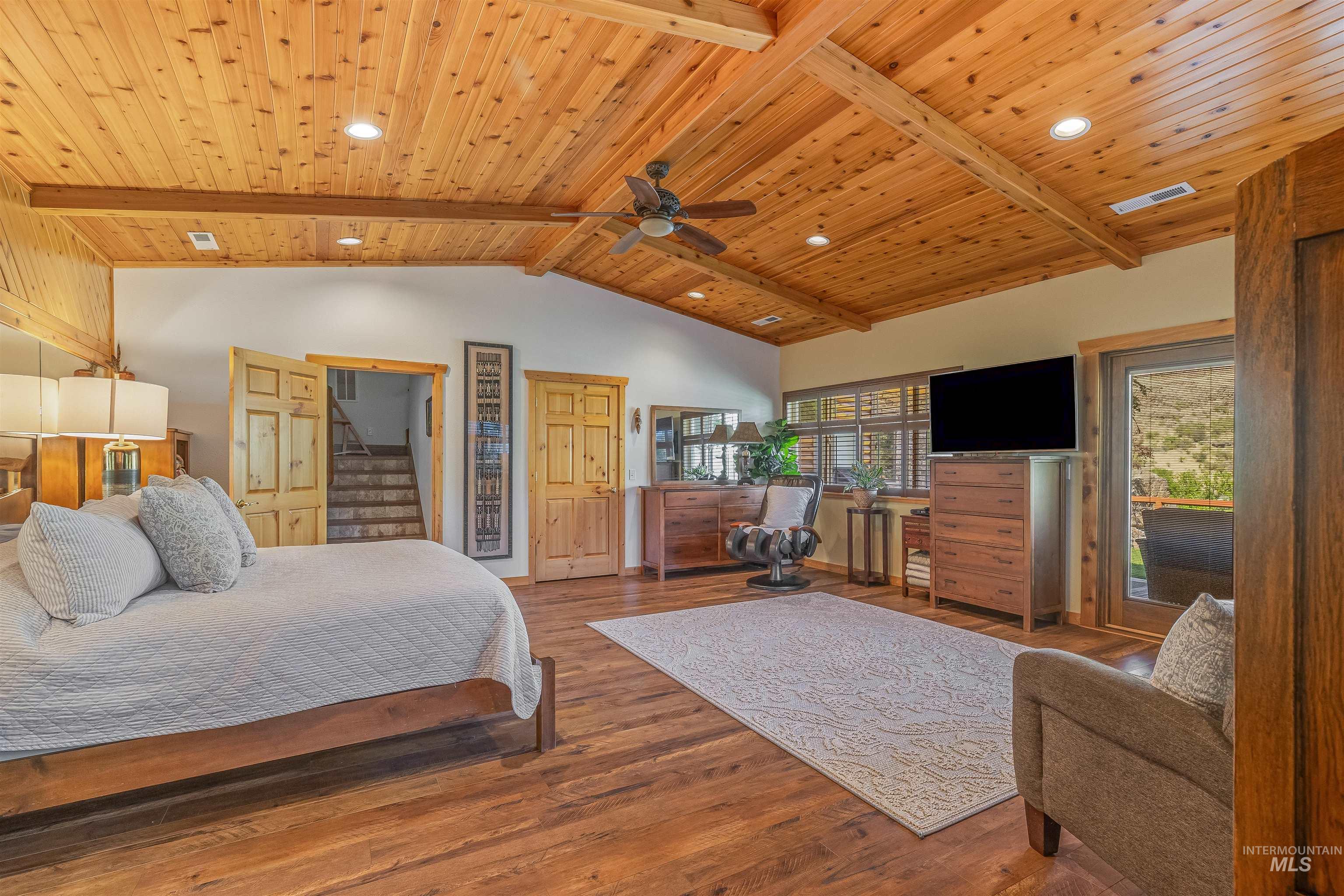 Bedroom with multiple windows, wood ceiling, wood finished floors, and recessed lighting