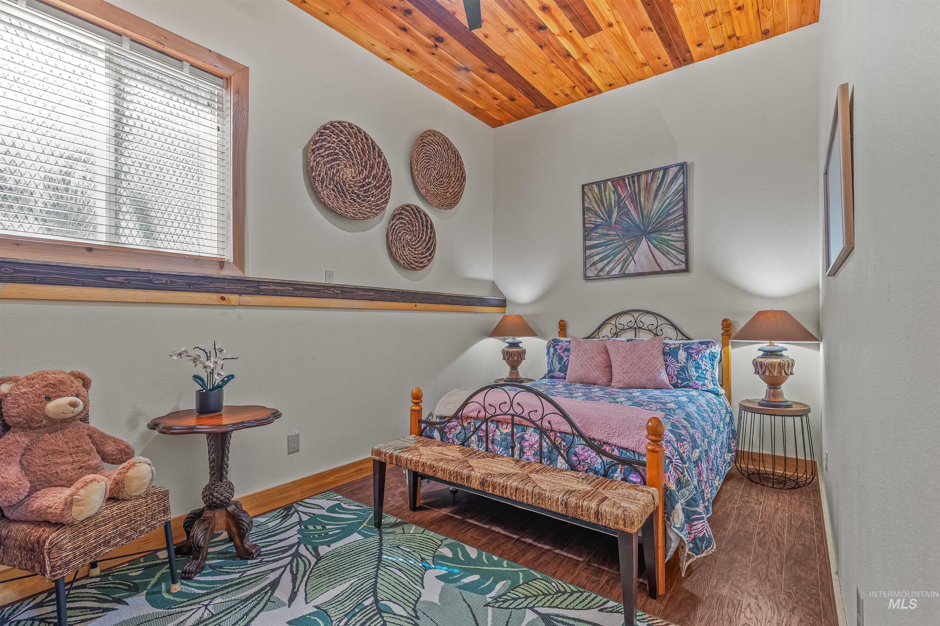 Bedroom with wood finished floors and wood ceiling