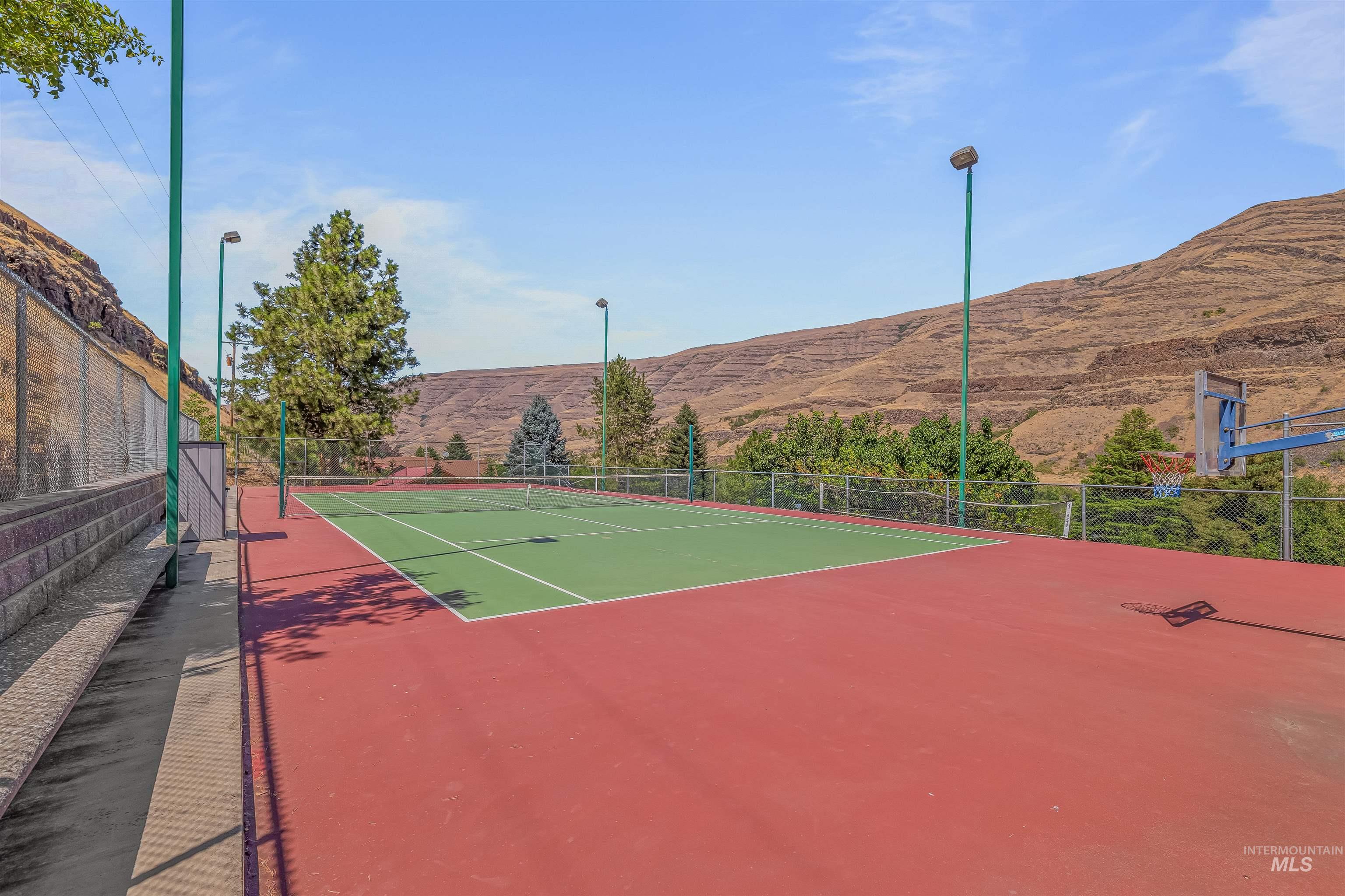 View of tennis court featuring a mountain view