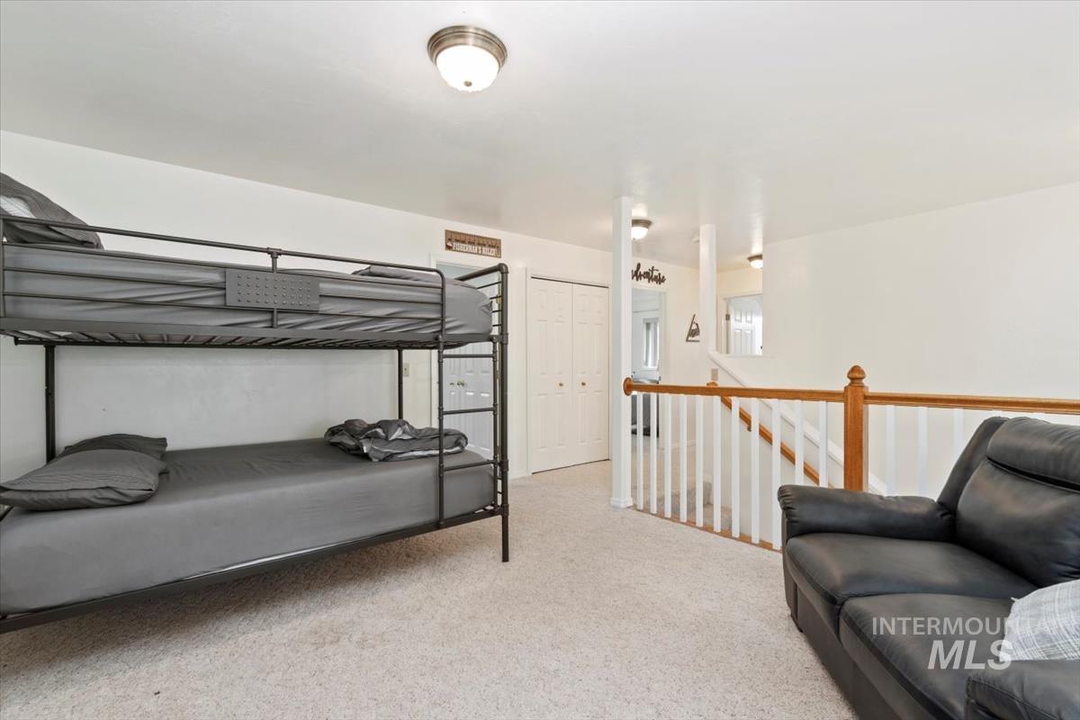 Carpeted bedroom featuring a closet