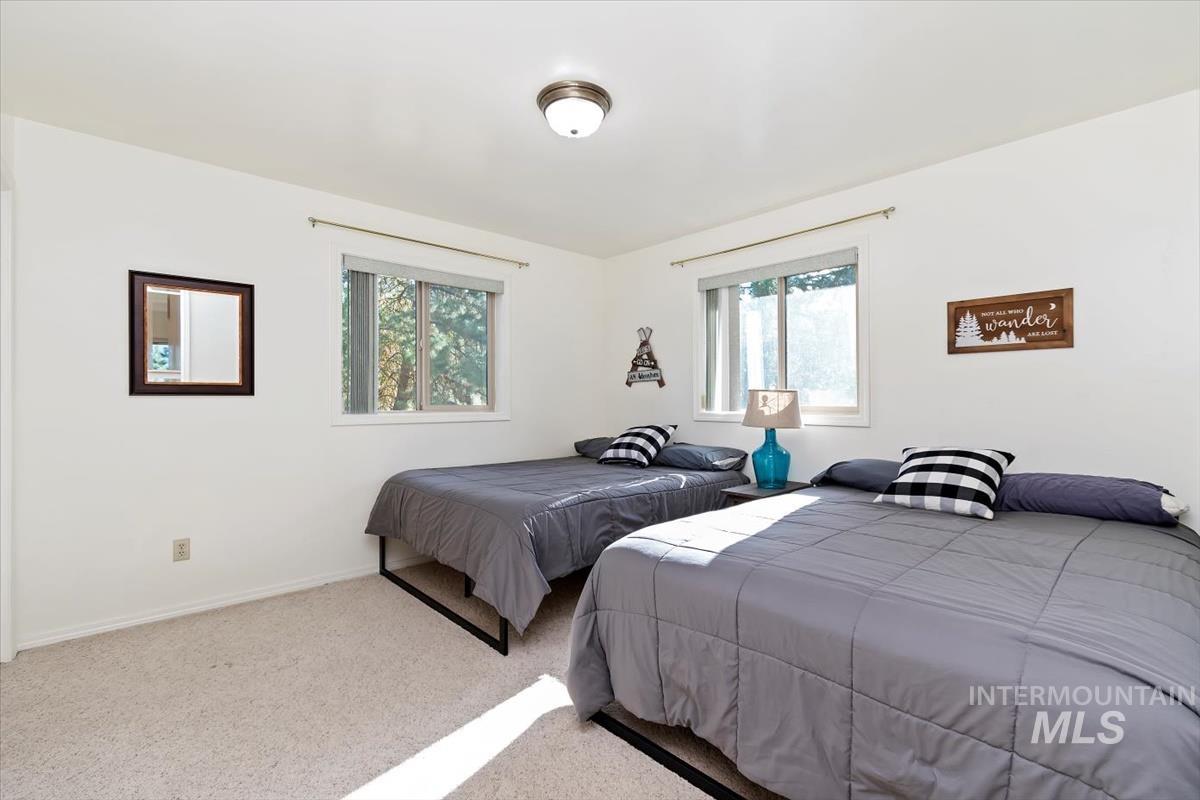 Bedroom featuring baseboards and carpet flooring