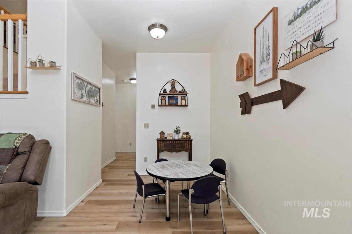 Dining space with light wood-style floors and baseboards
