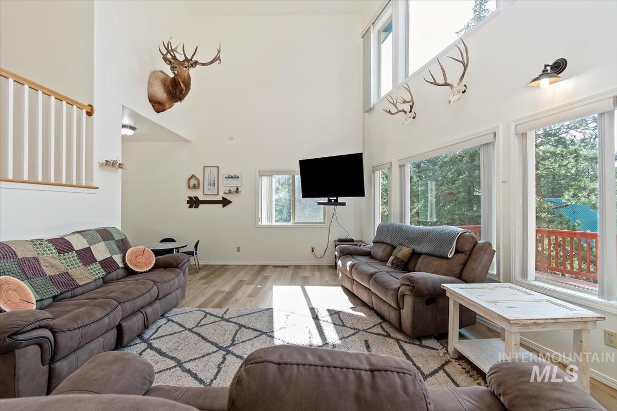 Living room with wood finished floors and a high ceiling