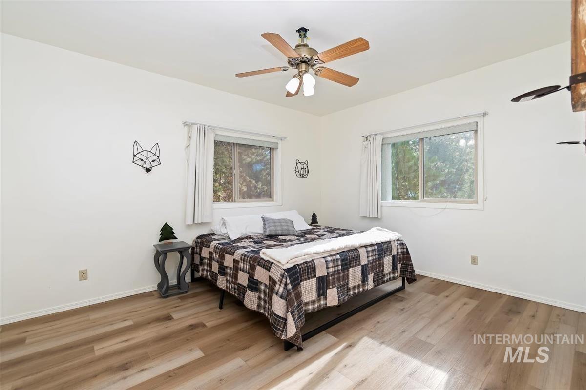 Bedroom featuring light wood-style flooring and a ceiling fan