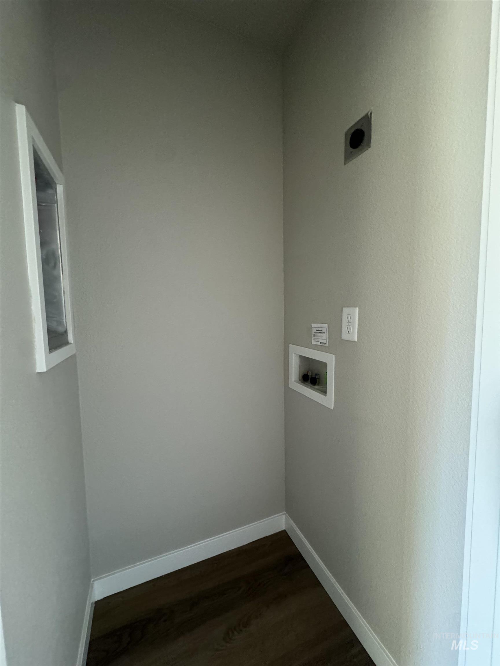 Washroom featuring washer hookup and dark wood-style floors
