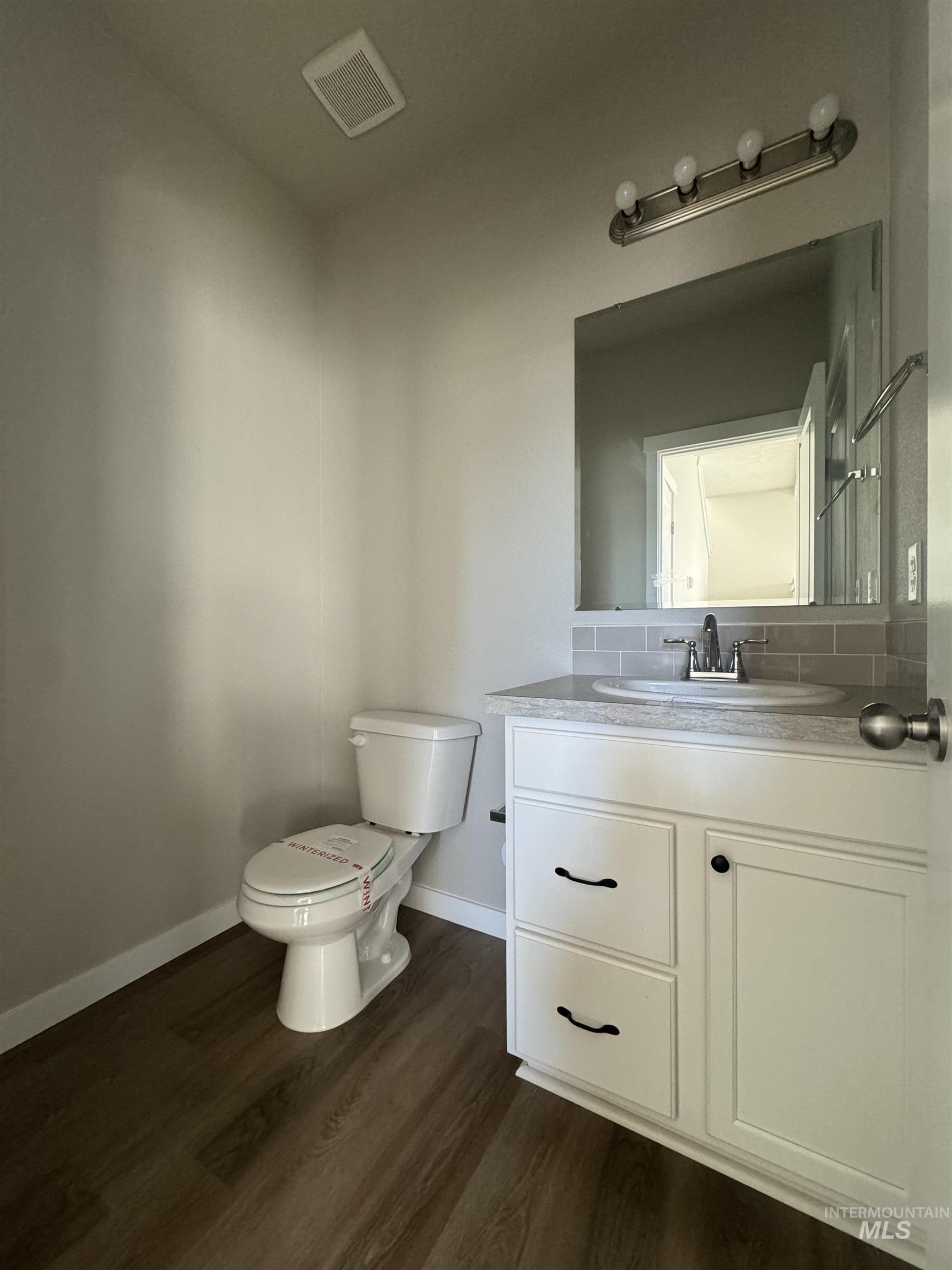 Bathroom with vanity and dark wood finished floors
