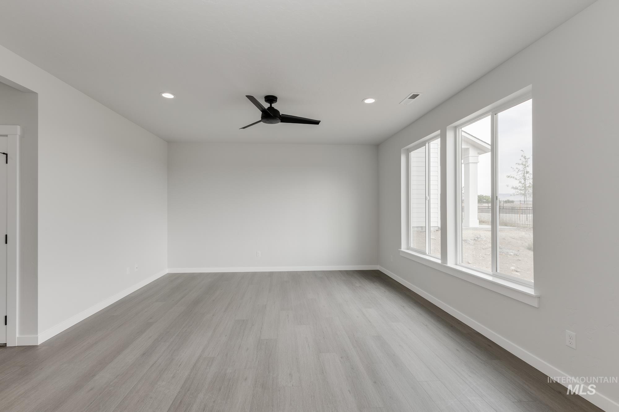 Unfurnished room with light wood finished floors, recessed lighting, and a ceiling fan