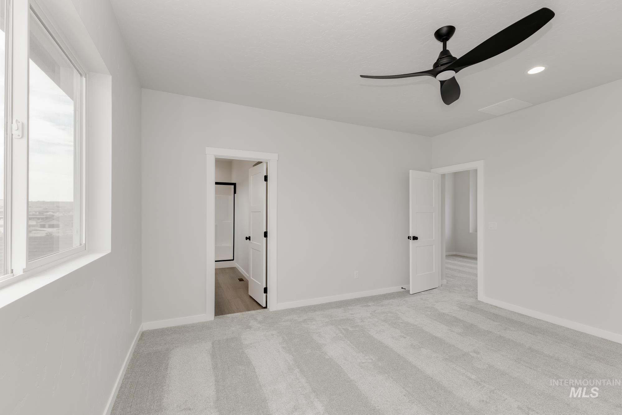 Unfurnished bedroom with light colored carpet, a ceiling fan, and recessed lighting