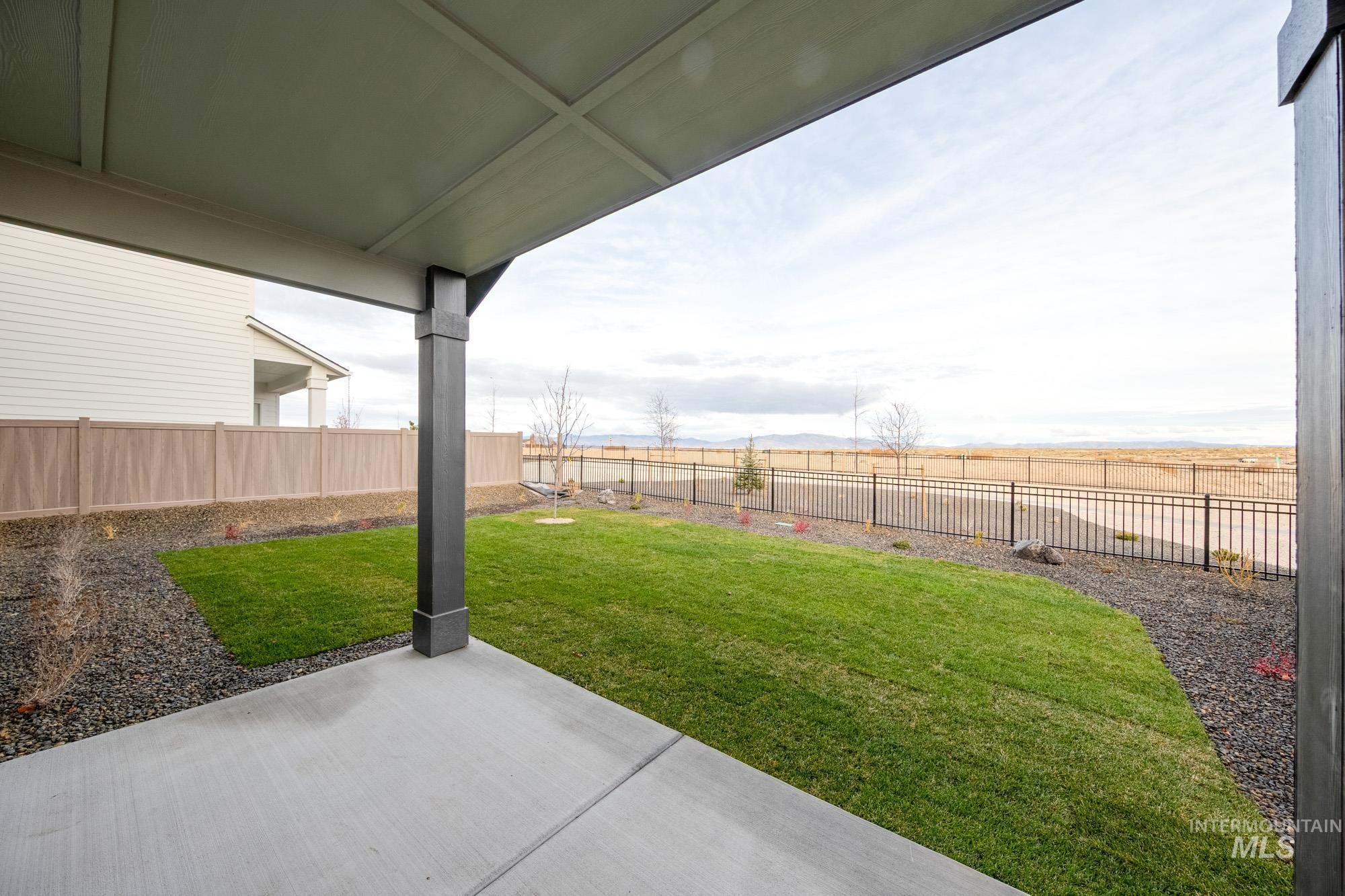 Fenced backyard featuring a patio