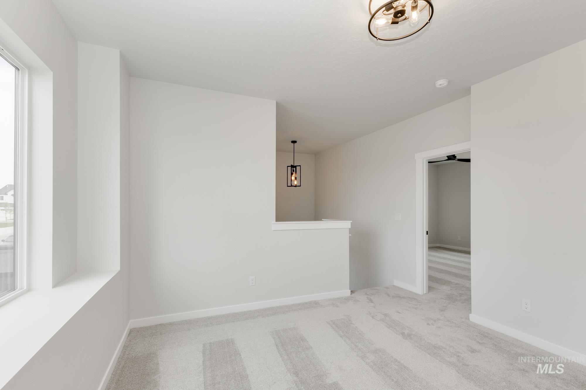 Empty room with carpet flooring and baseboards