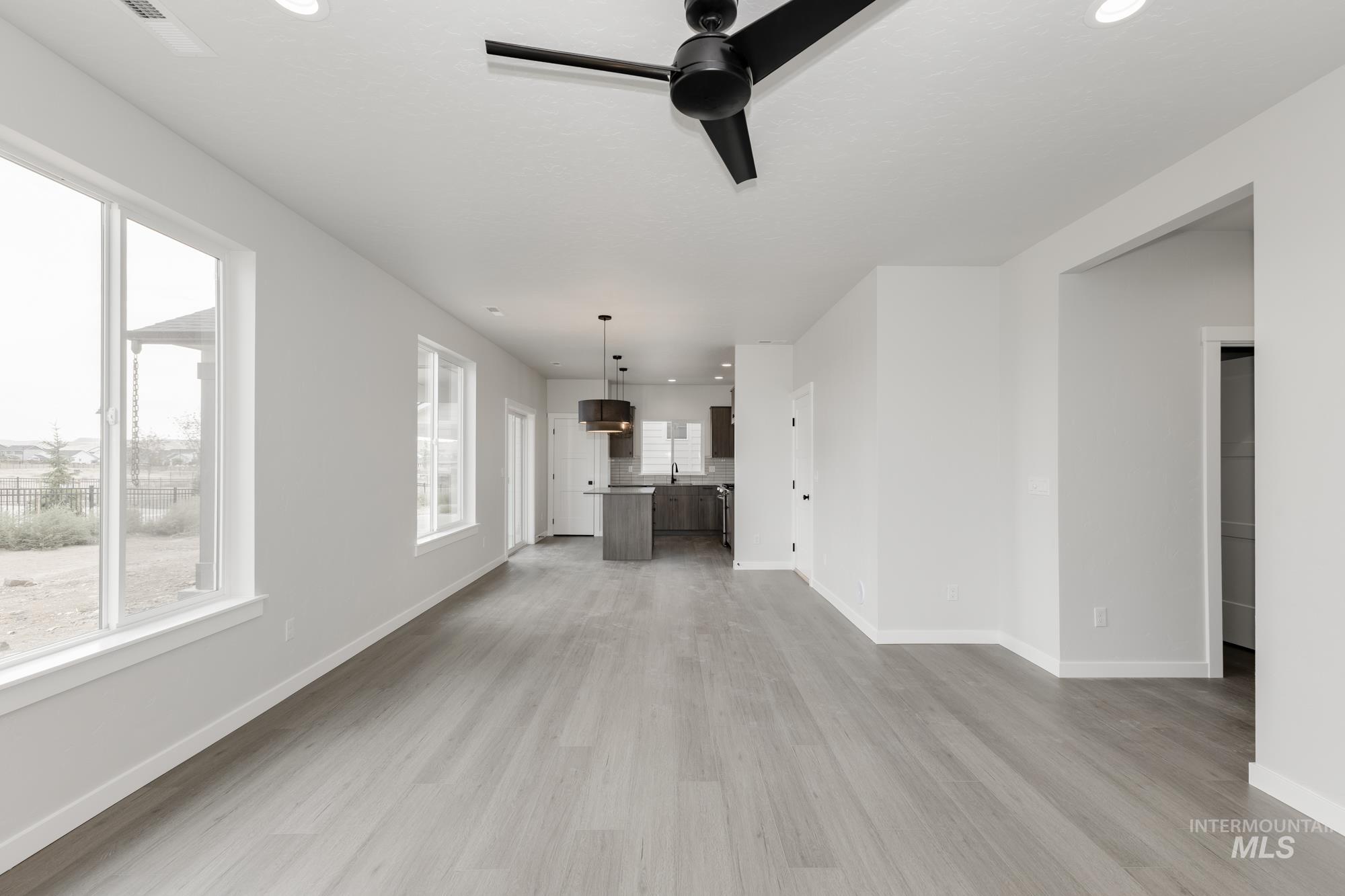 Unfurnished living room with light wood-style floors, recessed lighting, and ceiling fan