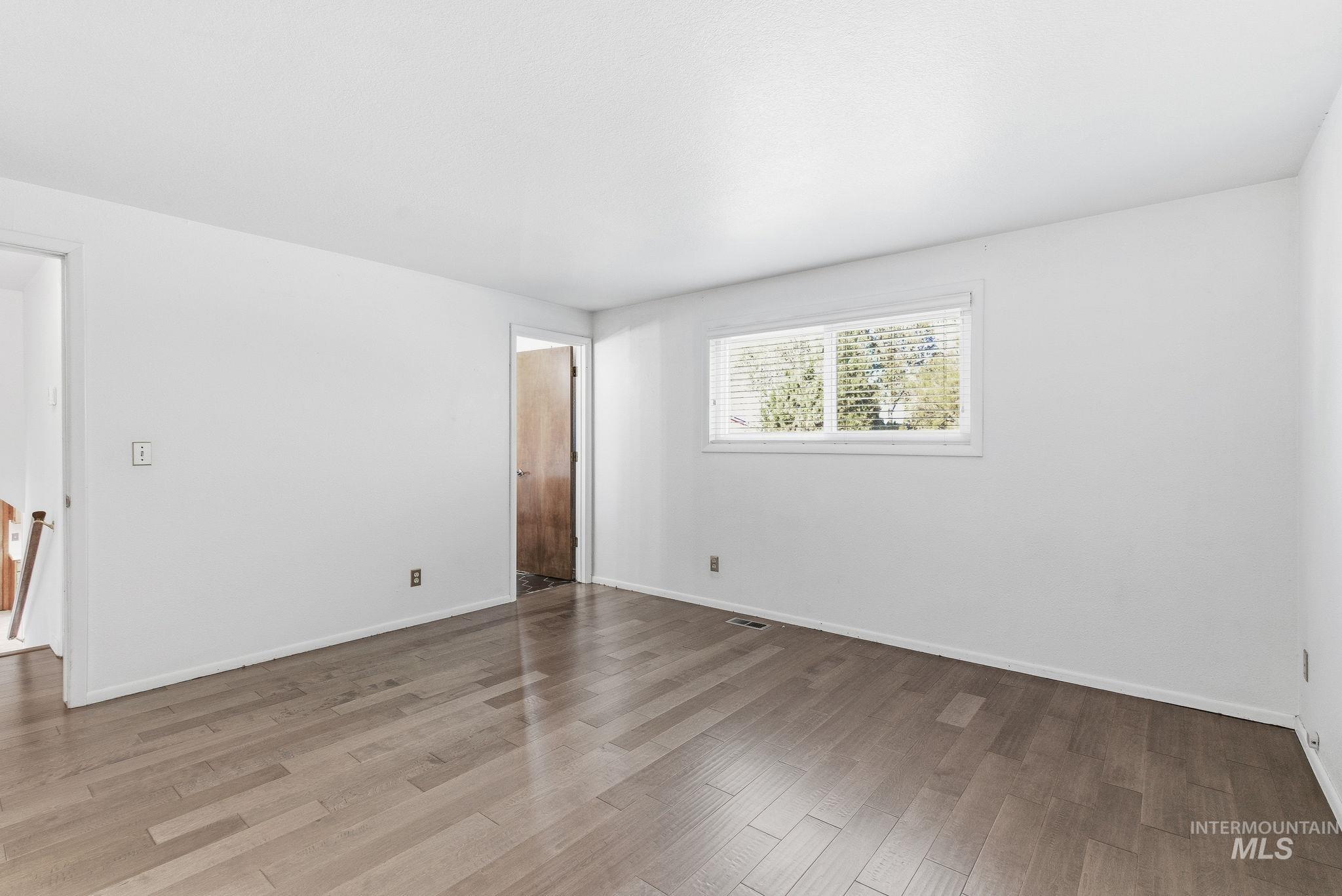 Empty room with wood finished floors and baseboards