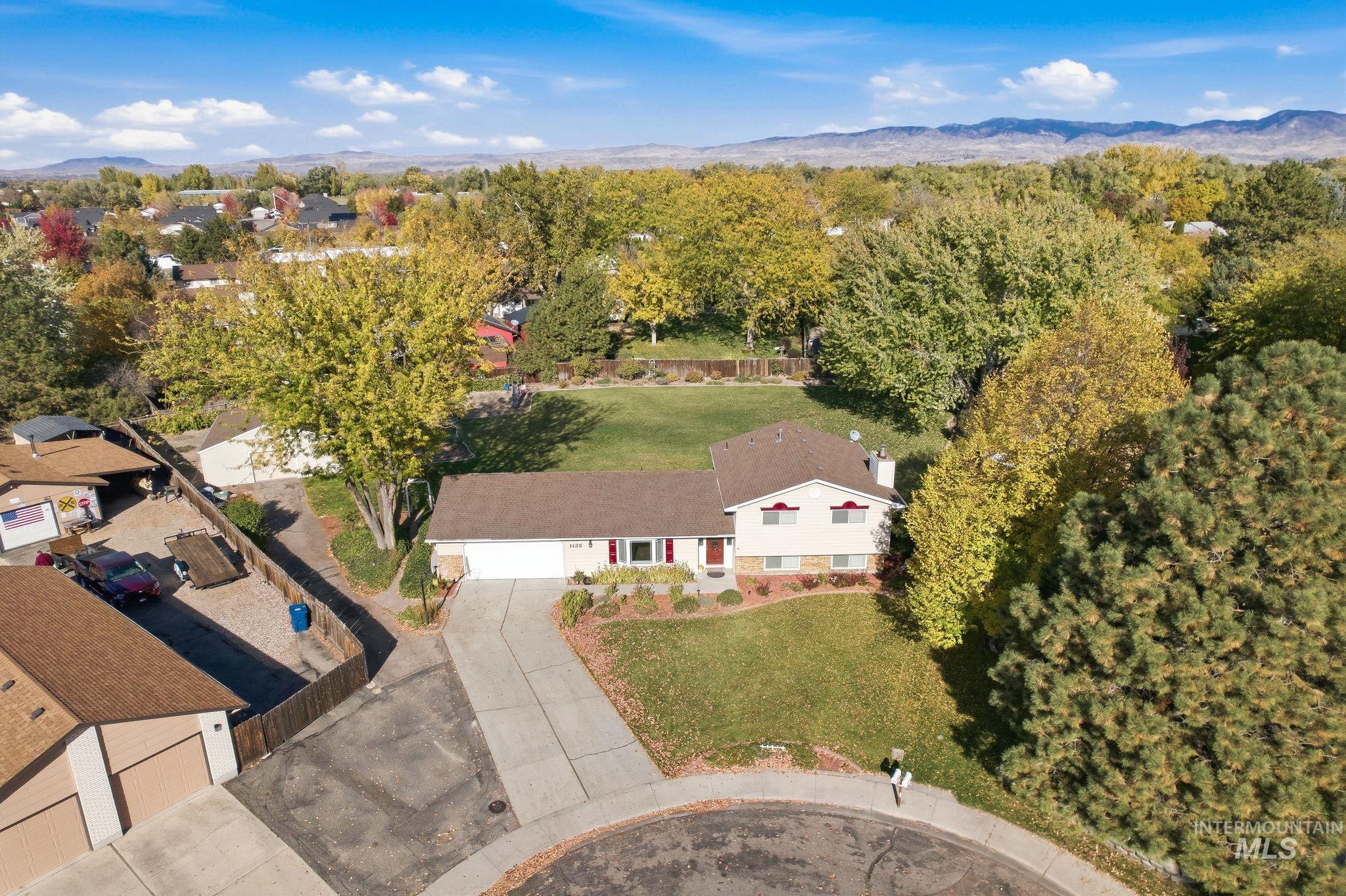 Aerial view of property and surrounding area with mountains