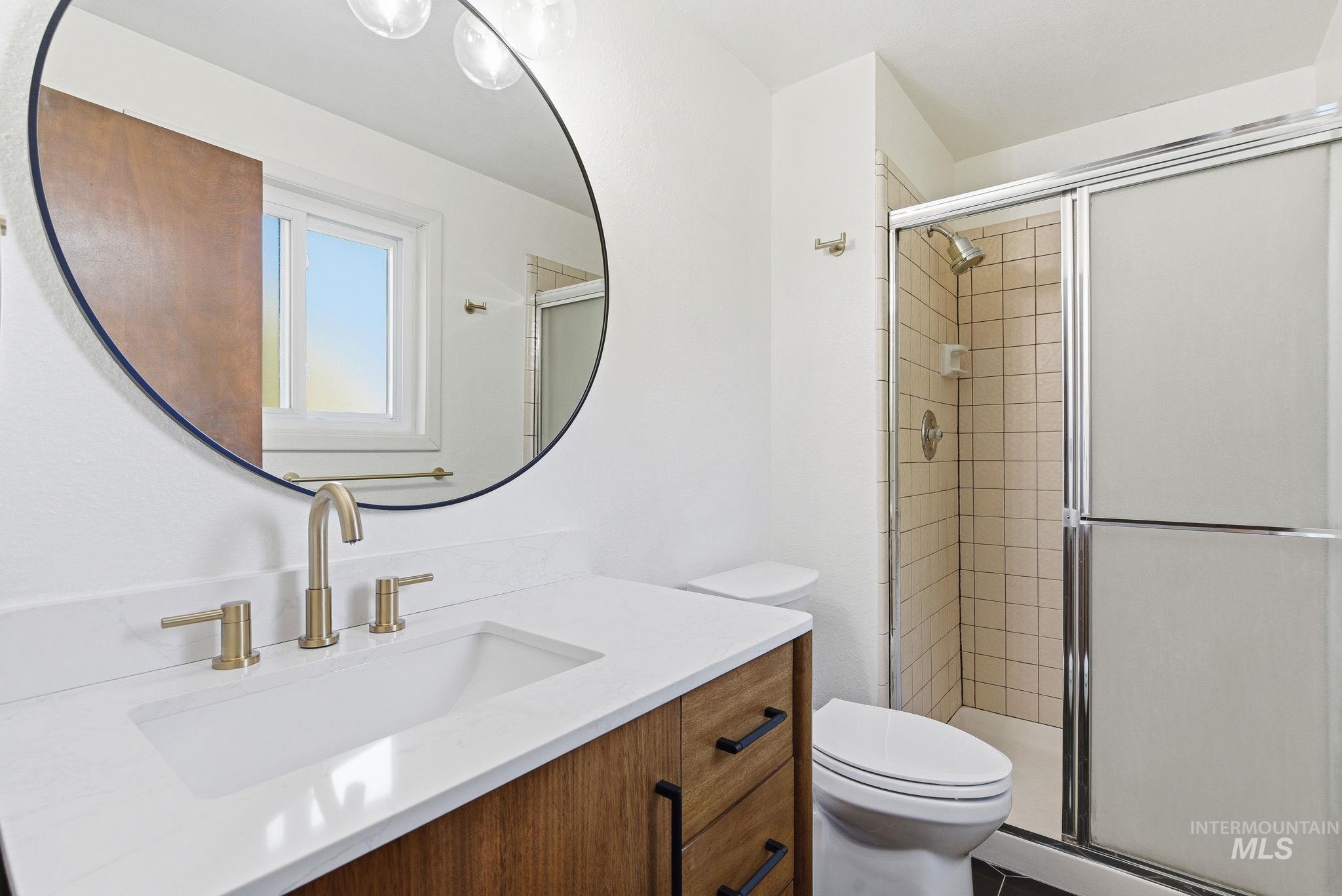 Full bath featuring vanity and a stall shower