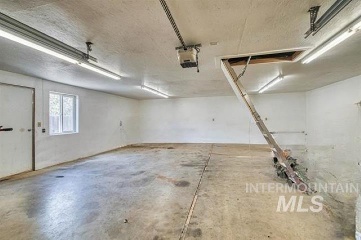 Garage featuring a garage door opener