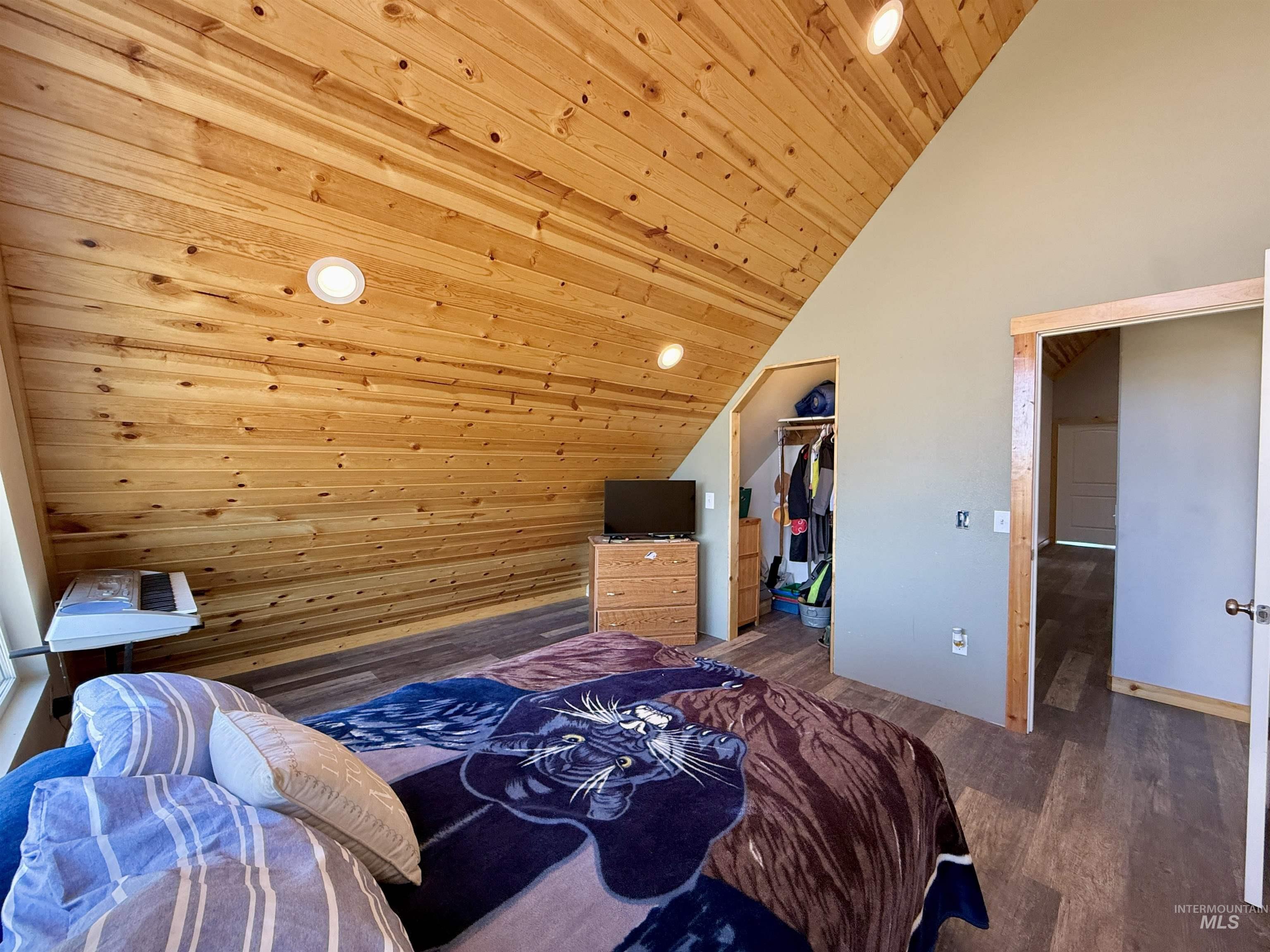 Bedroom featuring lofted ceiling, wooden ceiling, wood finished floors, and recessed lighting