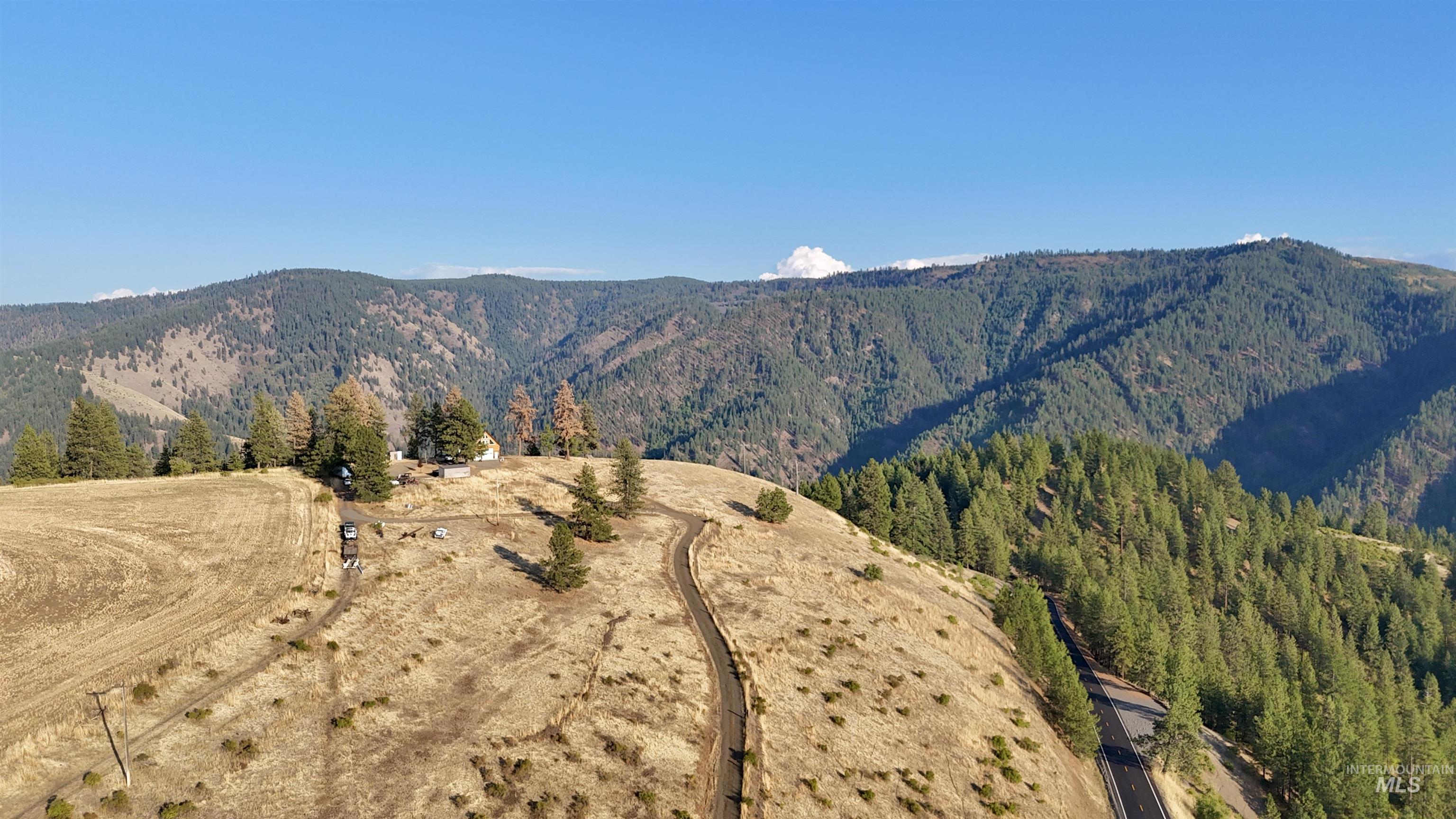 View of mountain backdrop featuring a forest and rural landscape