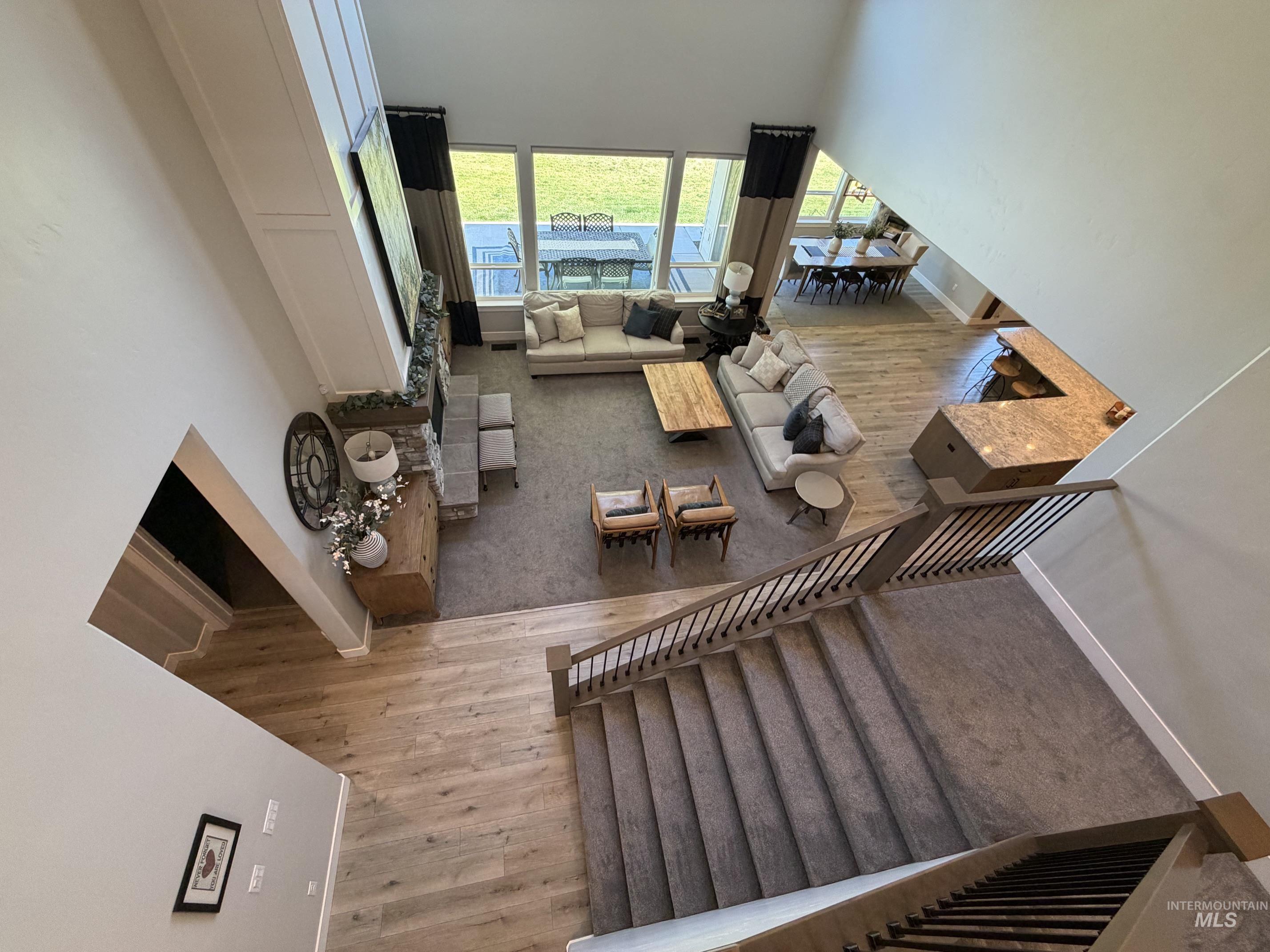 Expansive open-concept living space featuring a two-story ceiling and large windows