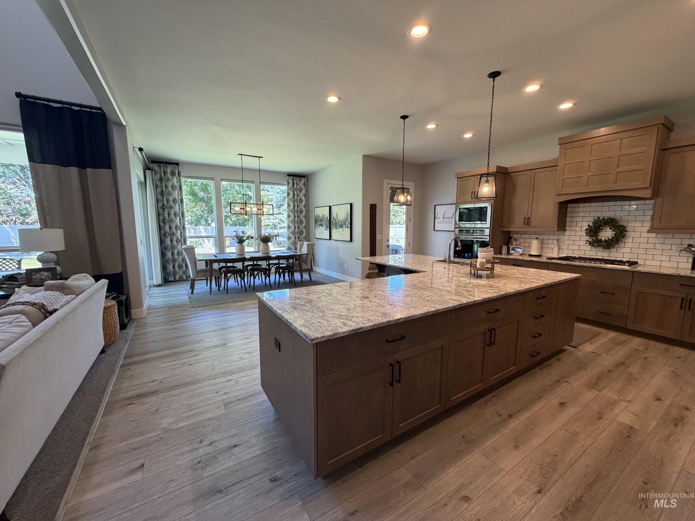 Open-concept interior featuring light wood-finish flooring throughout