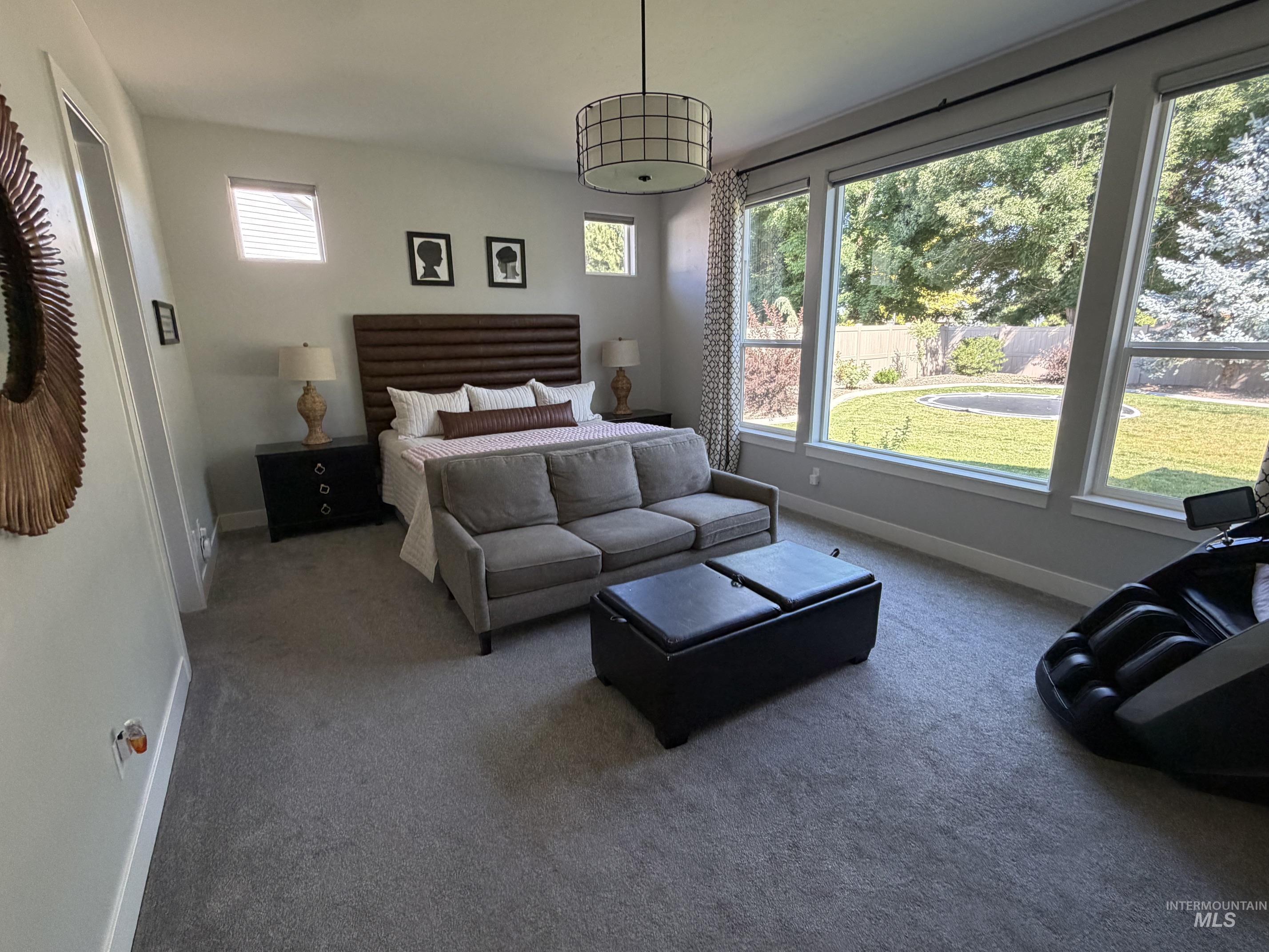 Spacious room featuring broad picture windows overlooking a green landscape