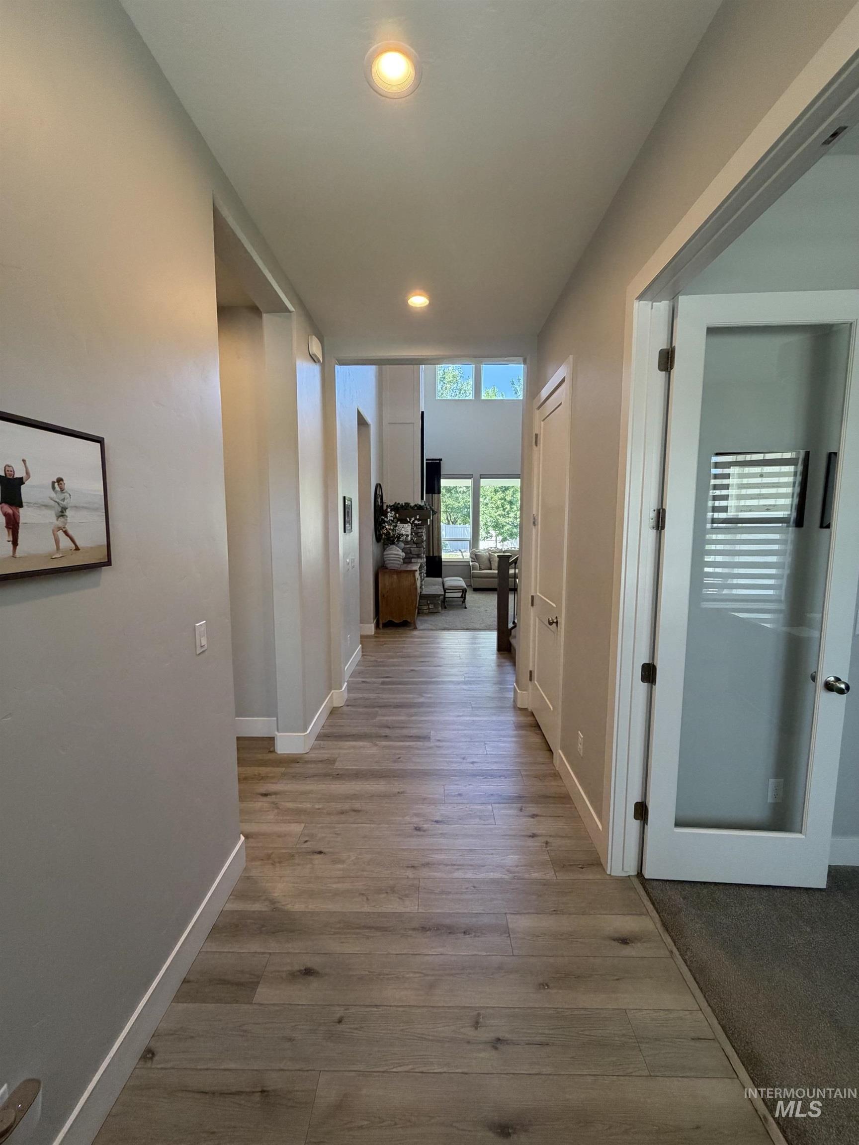Hallway featuring wood-finish flooring and recessed lighting