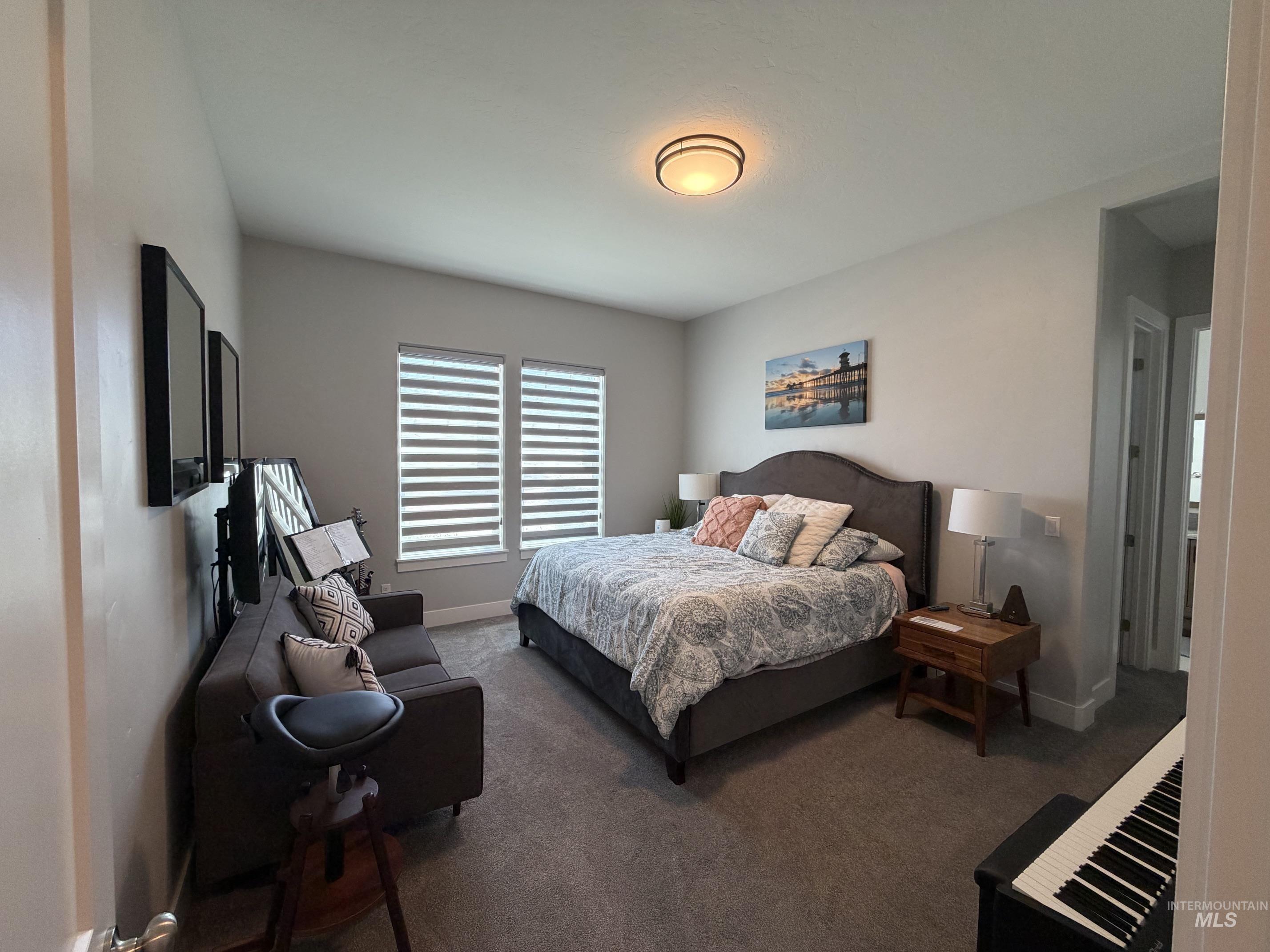 Bedroom featuring neutral grey walls and complementary grey carpeting