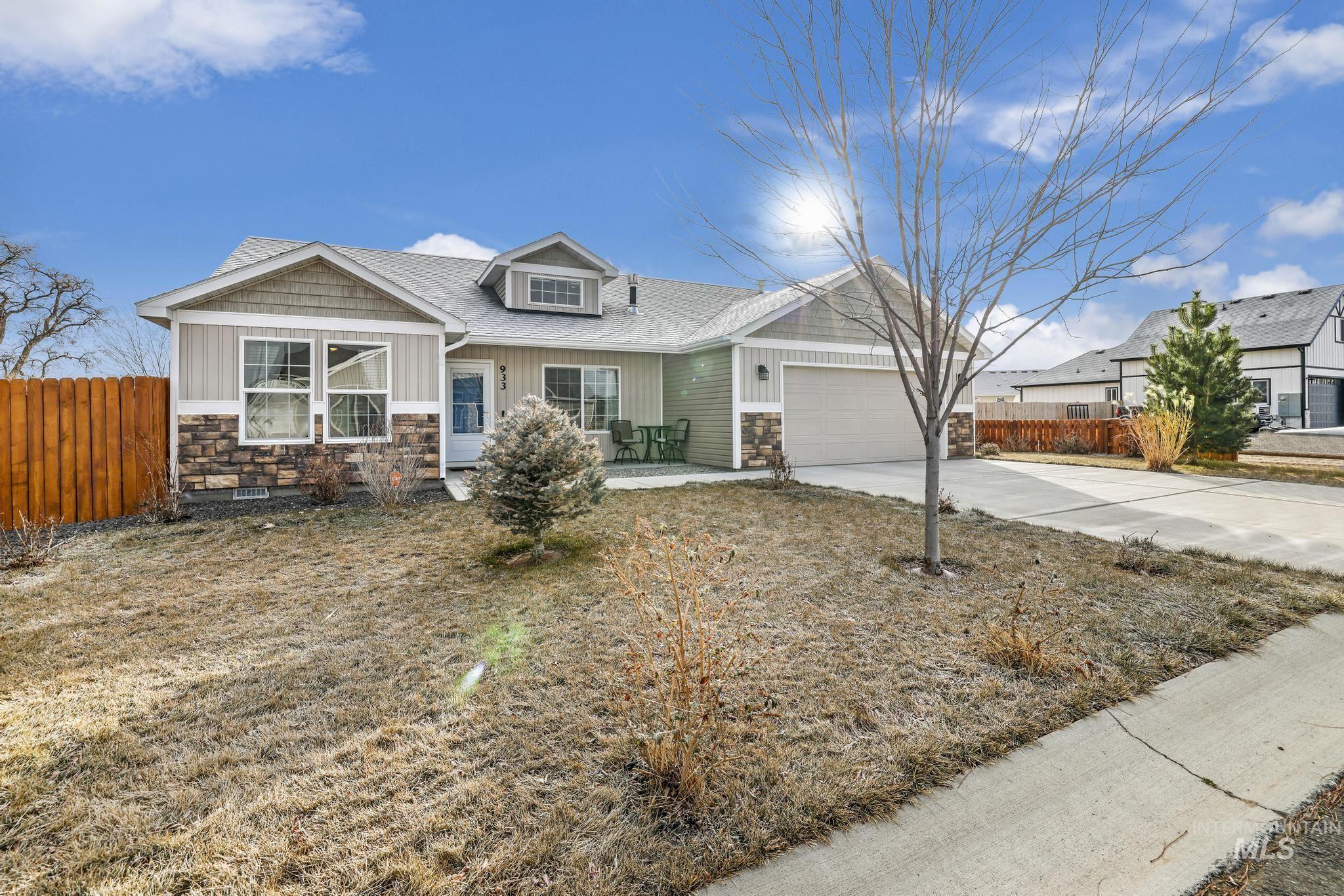 Craftsman house featuring stone siding, concrete driveway, board and batten siding, roof with shingles, and a garage