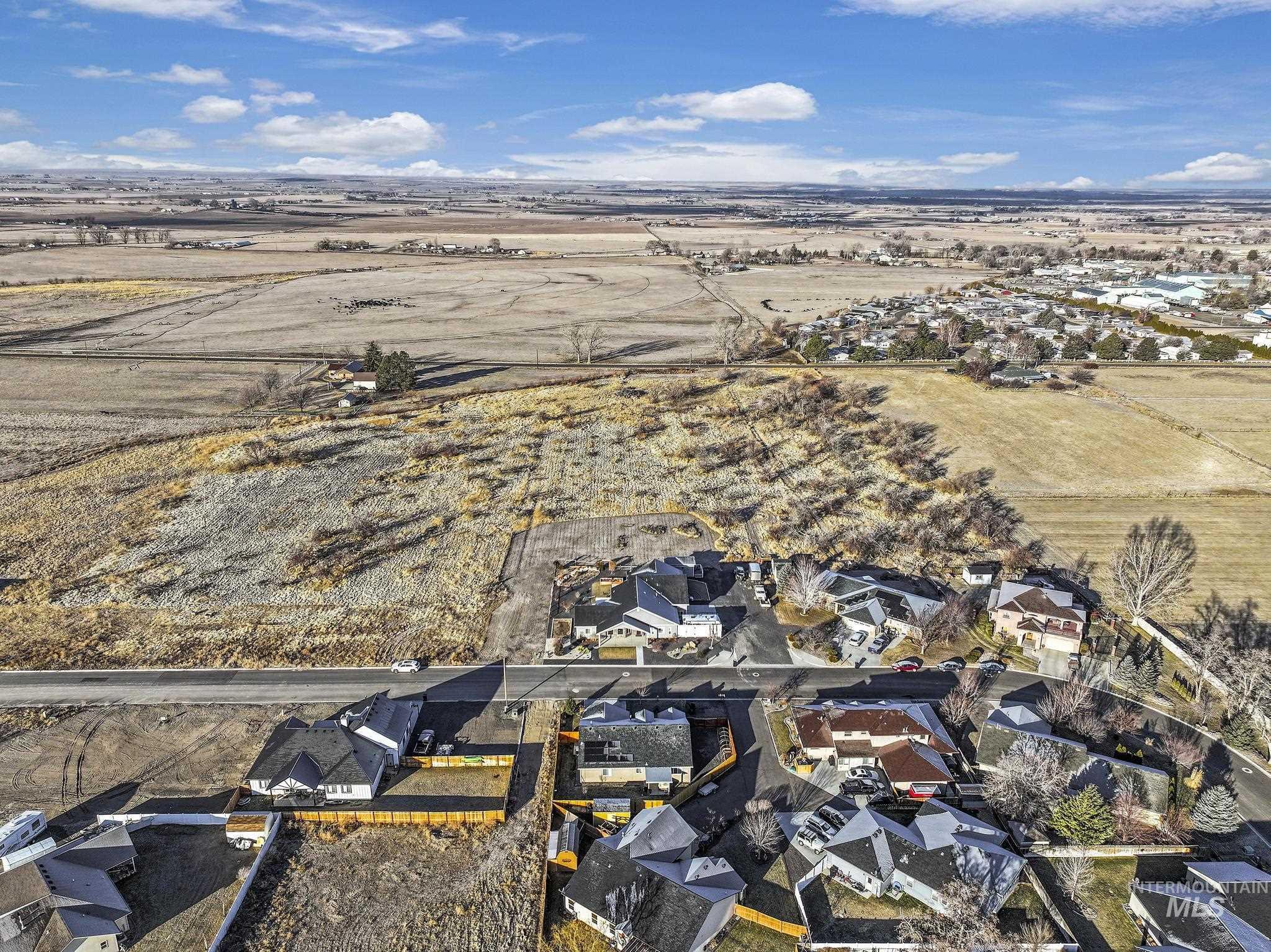 Aerial view of property's location featuring nearby suburban area and rural landscape