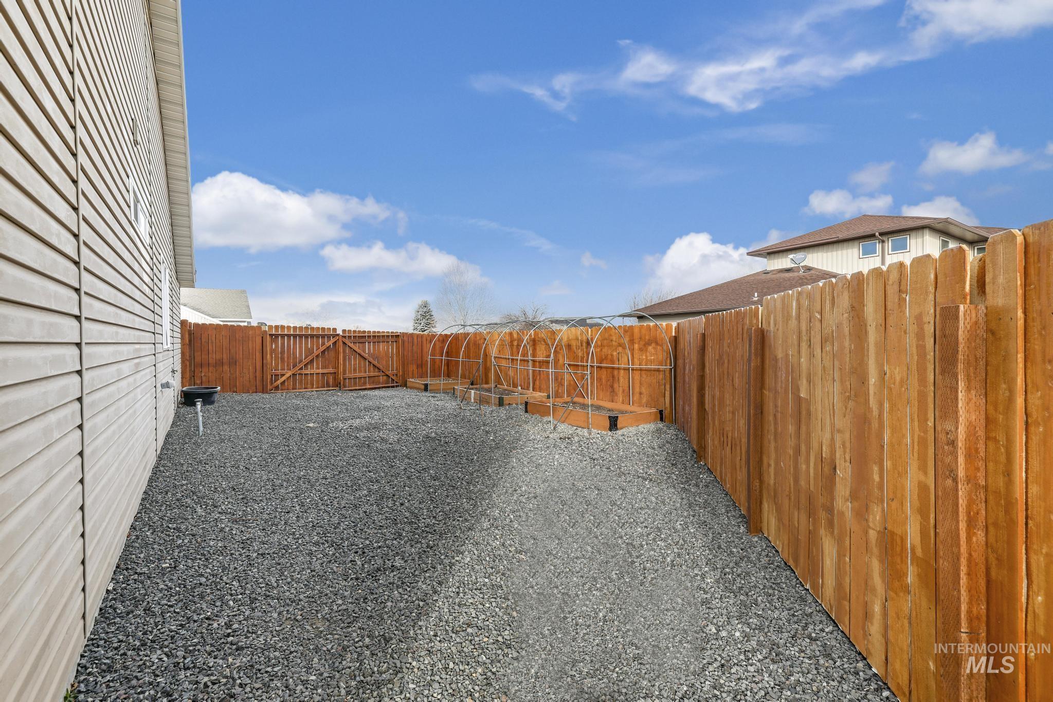 Fenced backyard featuring a gate