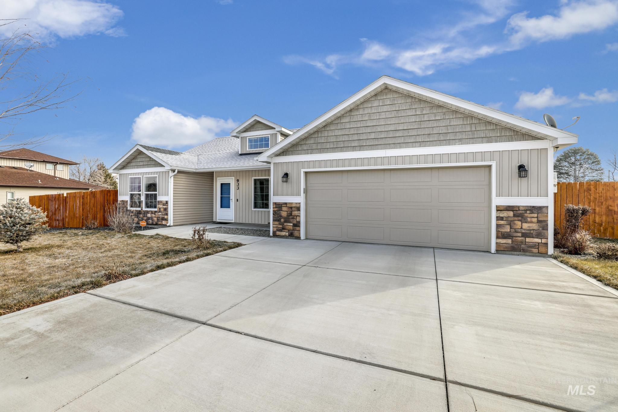 Craftsman house with stone siding, concrete driveway, a porch, and board and batten siding