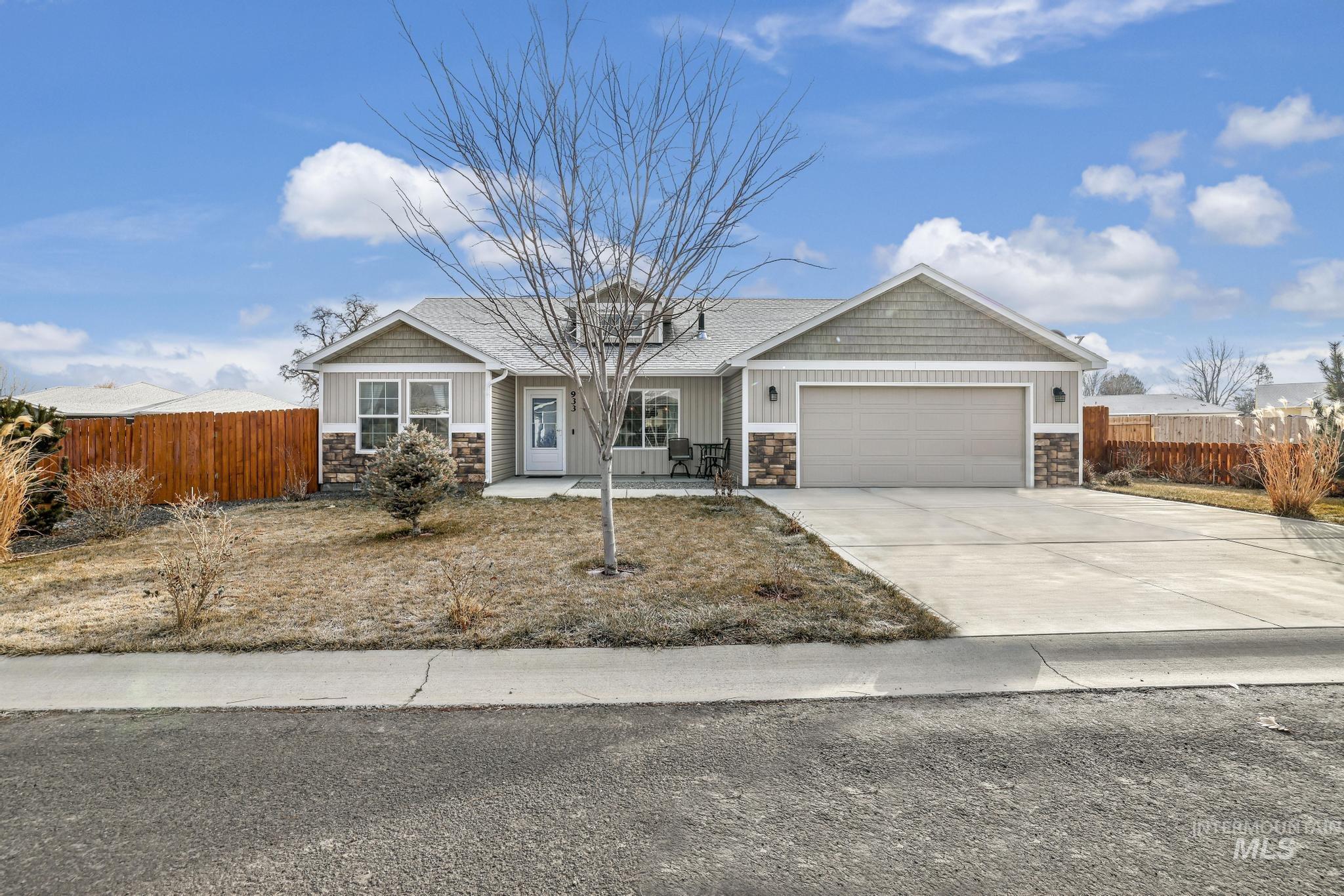 Craftsman-style home with stone siding, concrete driveway, a garage, and board and batten siding